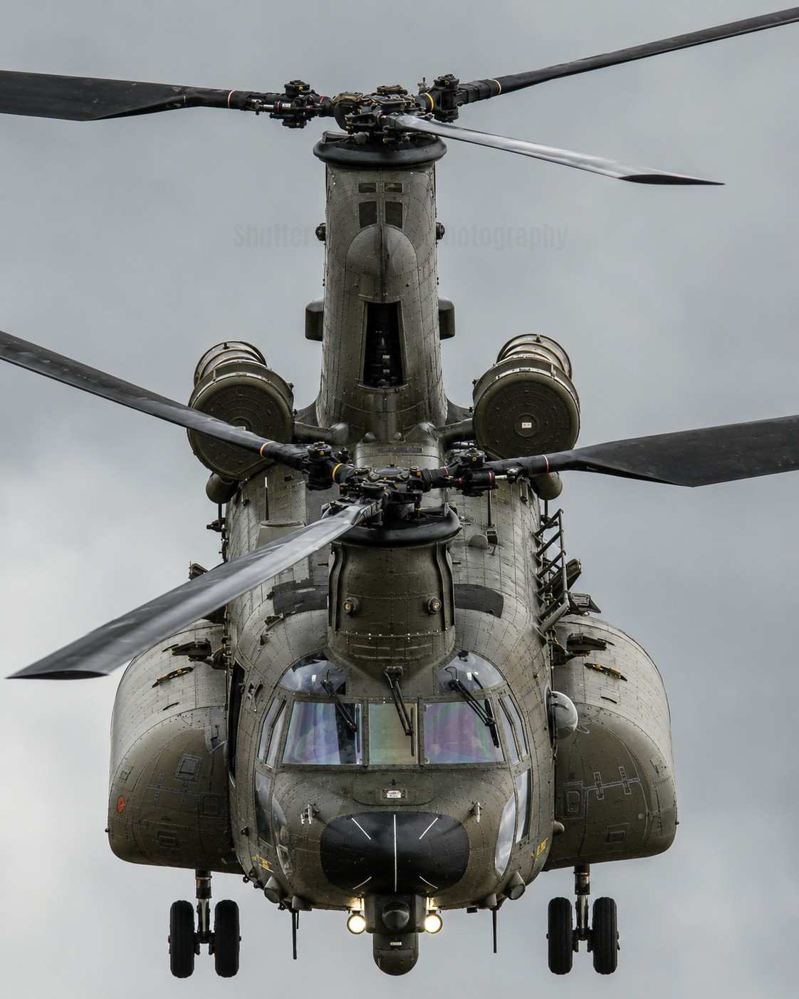 RAF Chinook departing head on with the intense blade slap and wide body, after a quick pit stop for food and water. The rumble and thunderous sight and sound of the power of this helicopter.