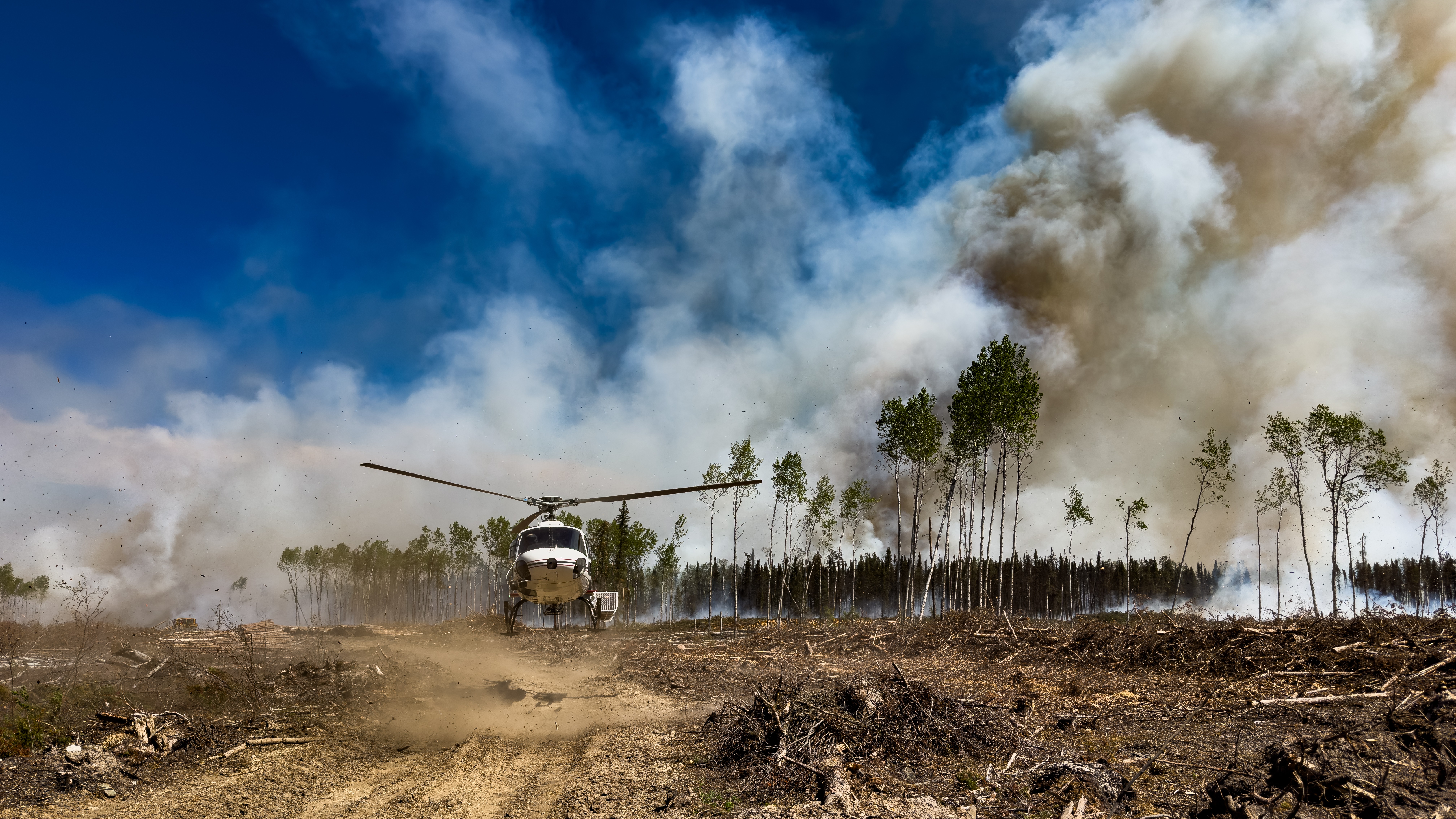 Astar landing to clear airspace for air attack. Helicopter was used as a reconnaissance machine to assess fire behaviour before tankers arrived. Northern Canada.