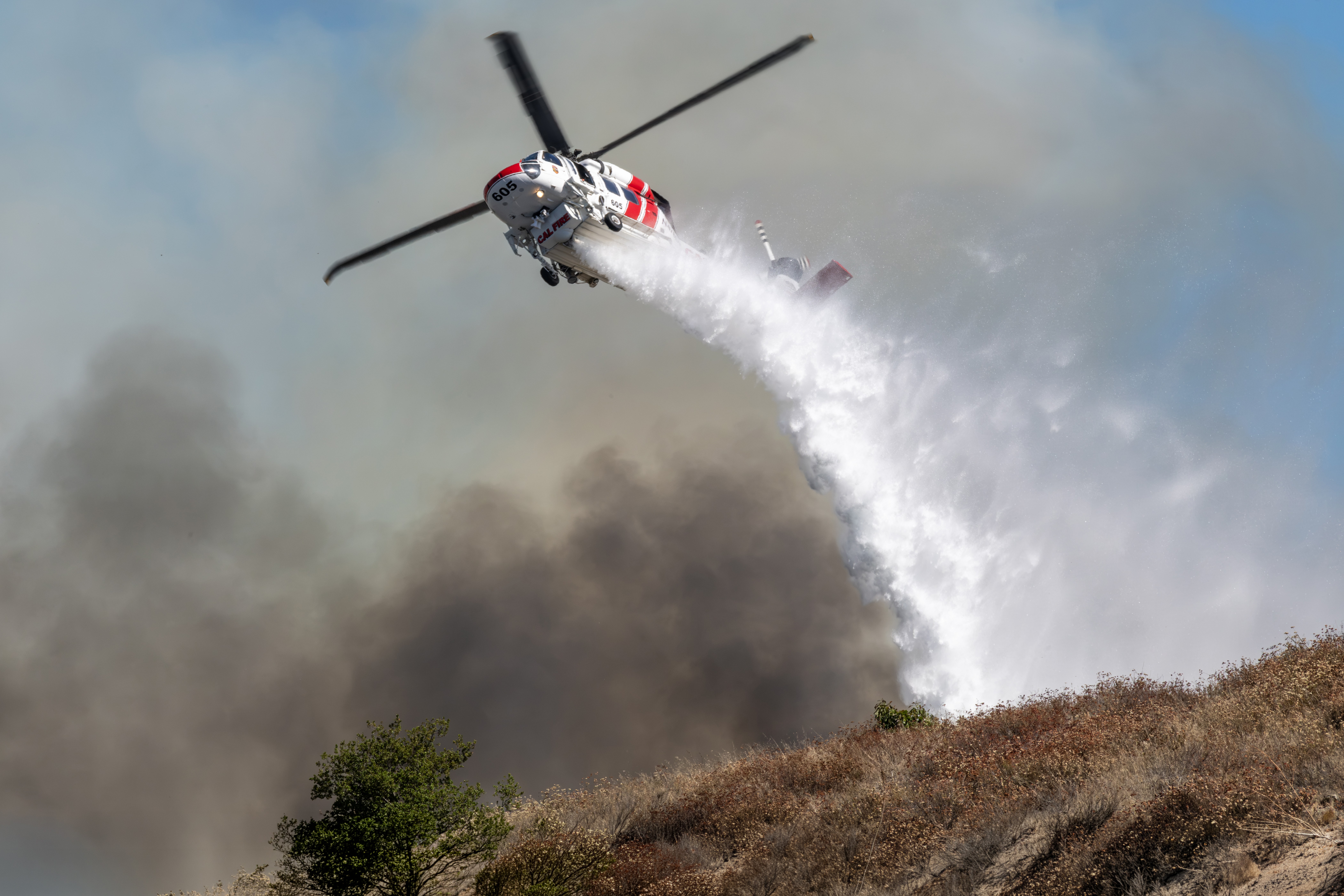 The Volcano Fire in Murrieta, California was burning in a beautiful community with some houses on hills surrounded by a valley.  I got permission to go in the backyard of a home overlooking the valley, which give me a great vantage point to photograph Cal Fire's Firehawk dropping water on an adjacent hill. The owners of the home I was photographing from were so nice and even asked if I needed anything to drink.