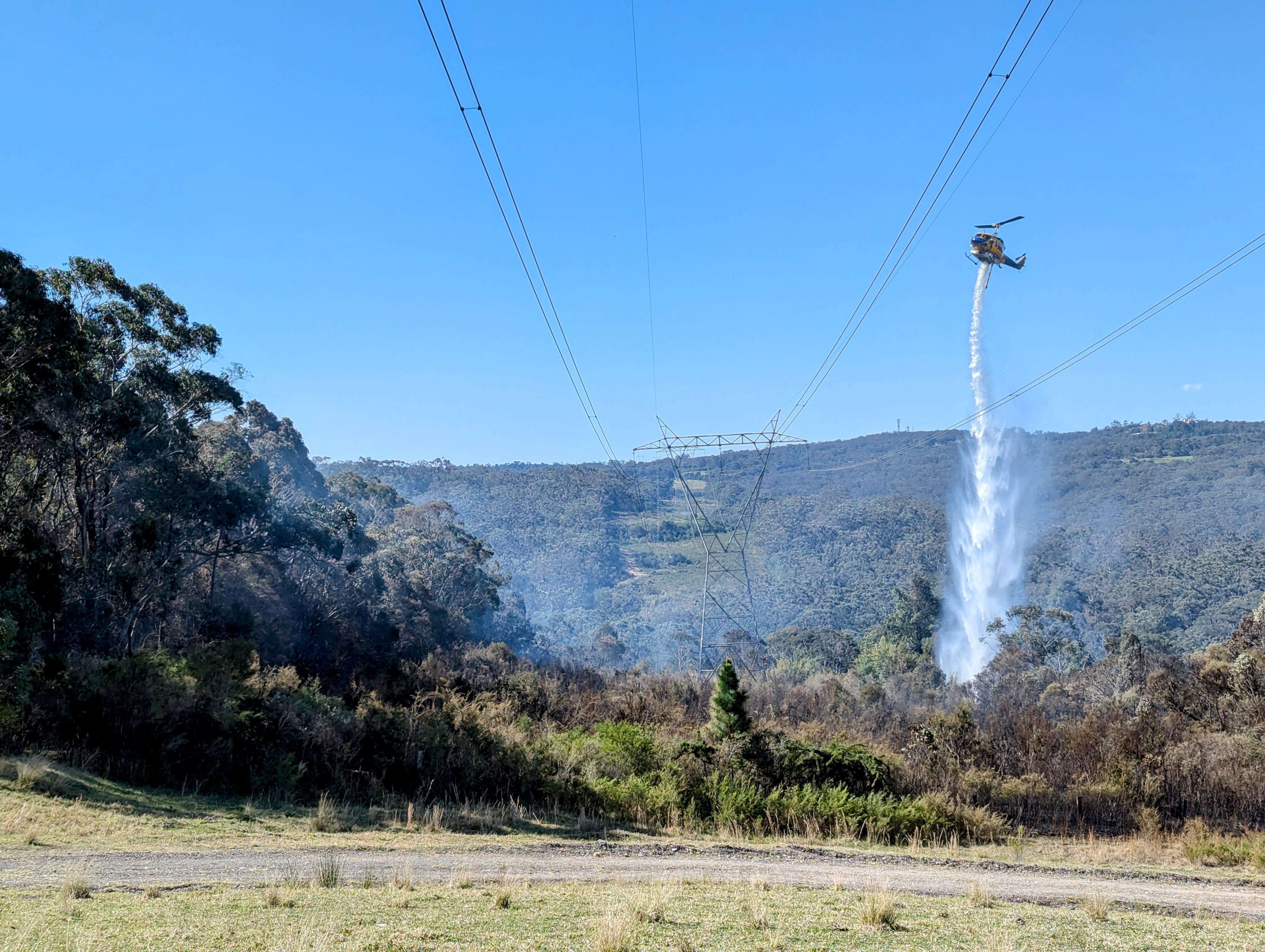 Power Easement Water Drop - Helicopters were the only option in the terrain, as major heavy plant wasn't viable. This belly tanker worked in conjunction with 3 bucket aircraft operators and the air attack supervisor to stop further fire extension in difficult areas and under very average weather conditions.