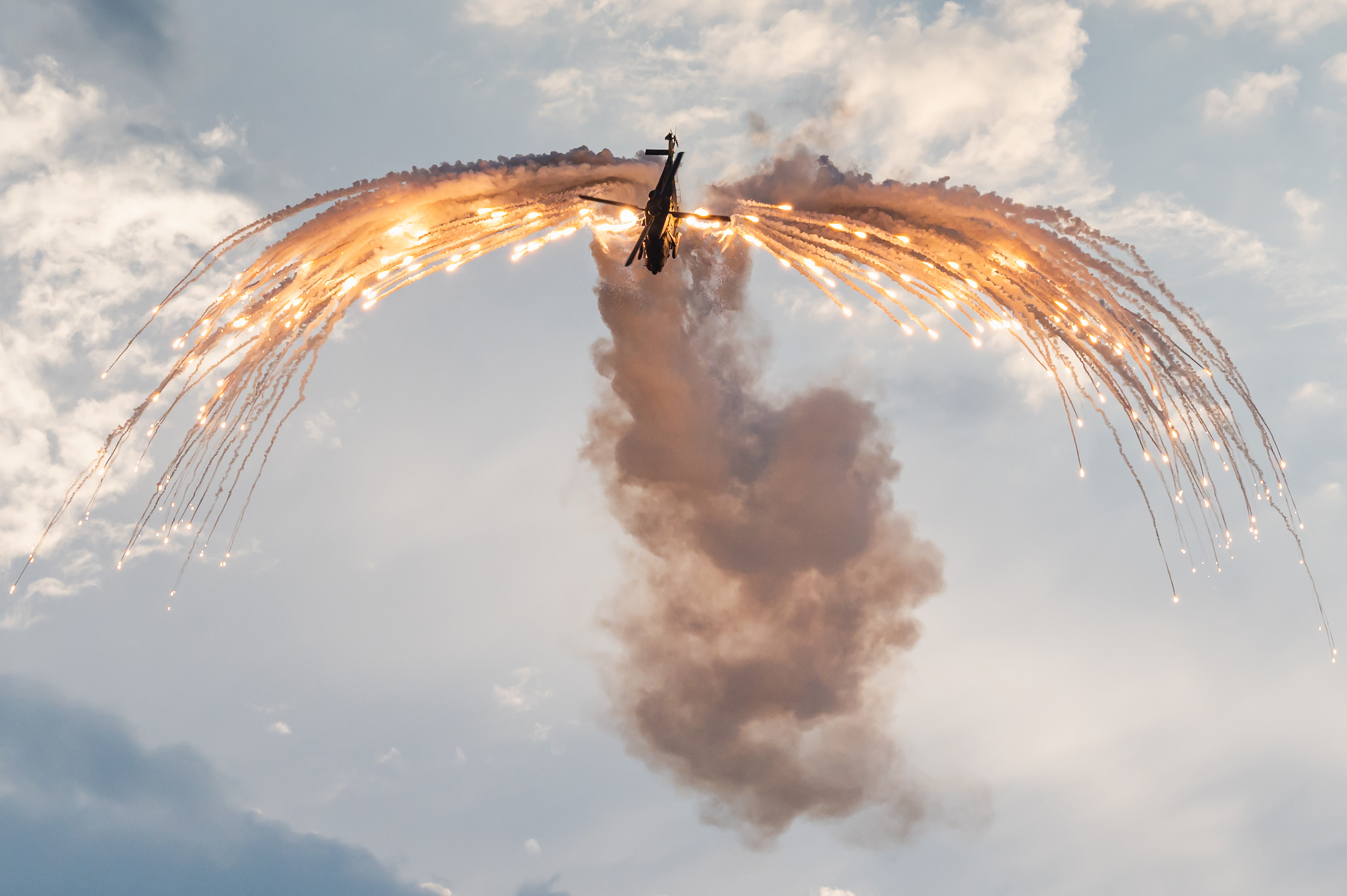 A NHIndustries NH90 Tactical Transport Helicopter of the German Army is performing a demonstration with flares at the Antidotum airshow in Leszno, Poland.