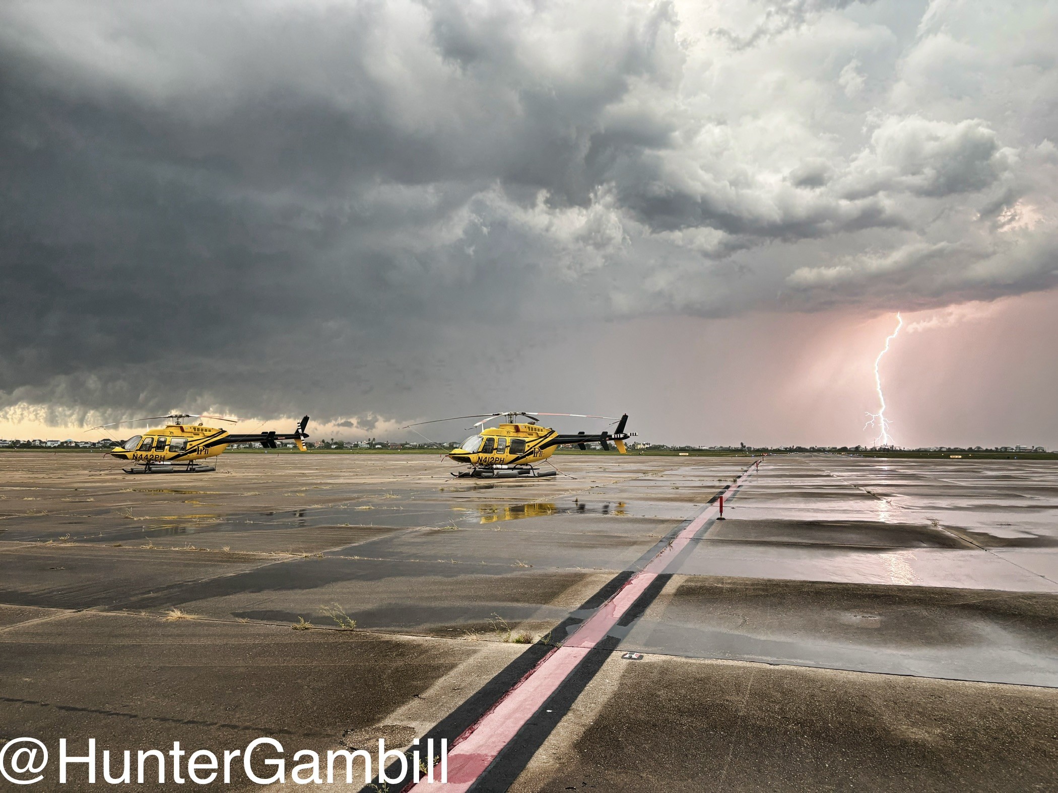 Two PHI 407s at KGLS, while storm passes through to the west