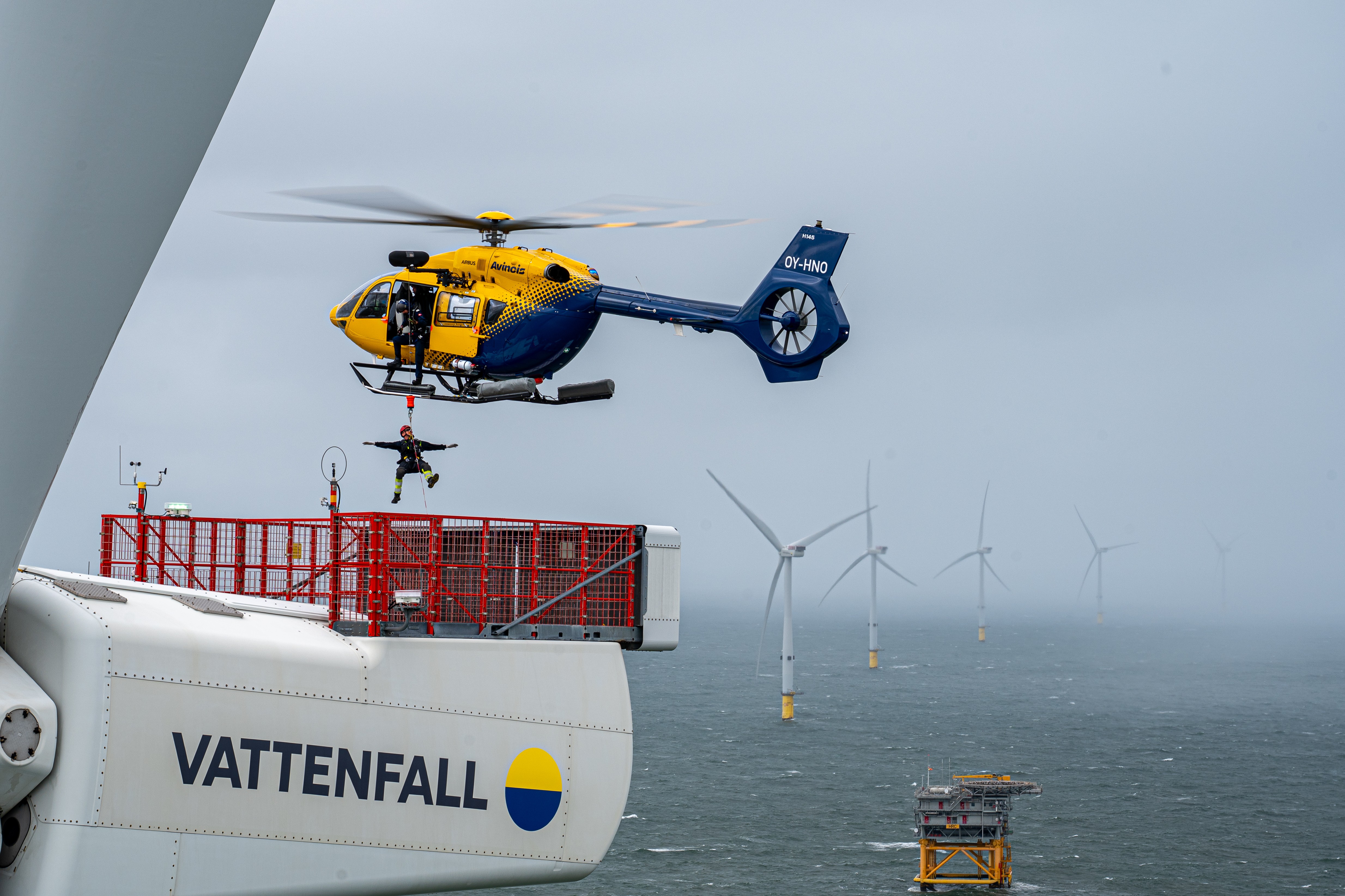 Technicians hoisted to a wind turbine for maintenance in the North Sea