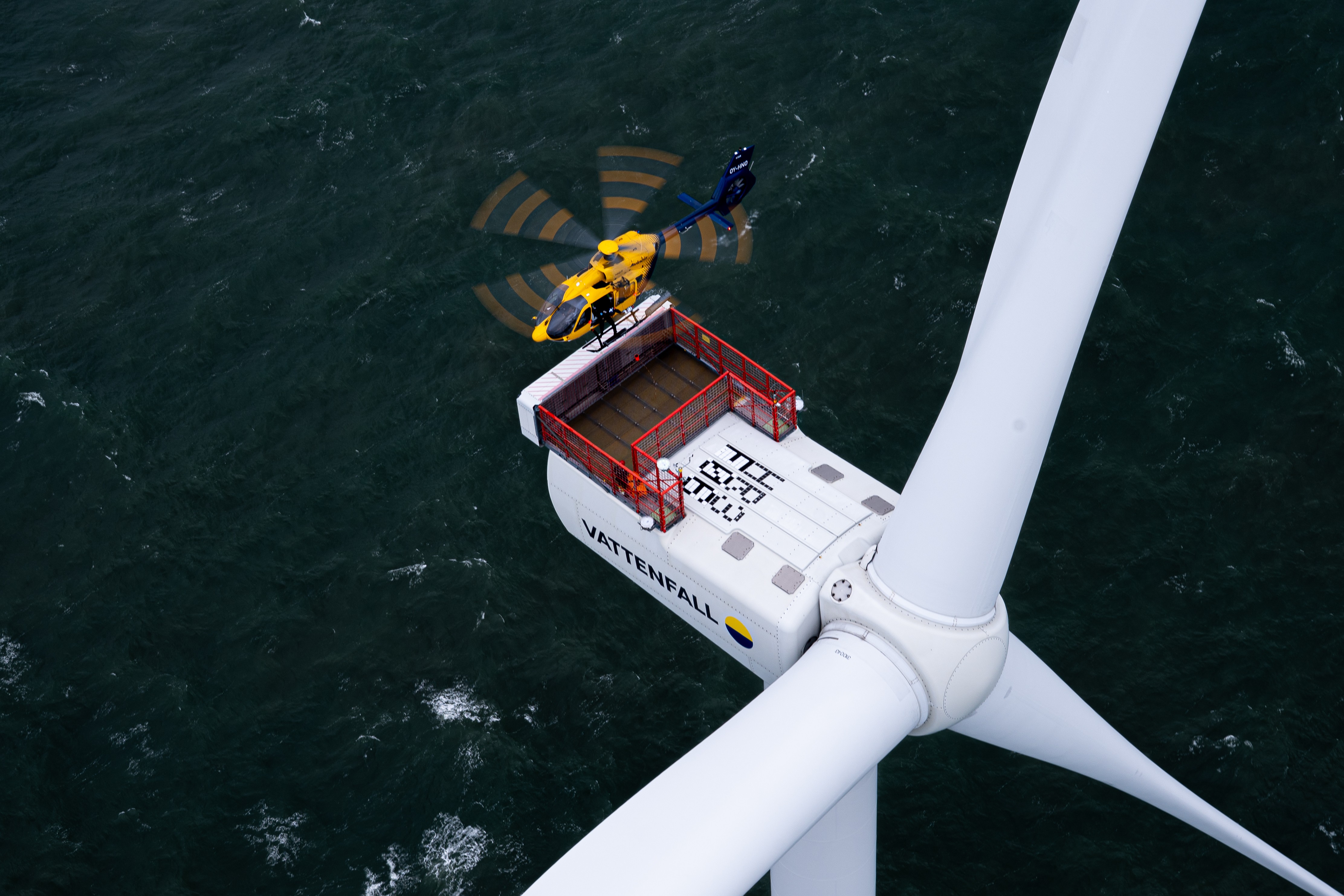 Airbus H145 in Avincis Aviation livery conducts a hoist onto a Vattenfall wind turbine in the North Sea. Operated by Avincis Aviation Denmark, these crews conduct hoist missions to deliver technicians and cargo to wind farms operated along Denmark's vast coastlines.