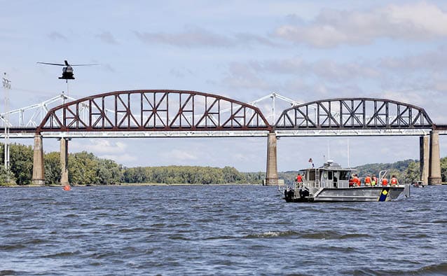New York Naval Militia Landing Craft (LC350) and patrol boat (PB-230) set a perimeter in the Hudson River off Schodack Island State Park as New York Army National Guard UH-60M Blackhawk conducts Bambi Bucket operations as part of exercise Empire Challenge on Sept. 6, 2024. (New York Naval Militia photo by Mass Communication Specialist 1st Class Stephanie Butler)