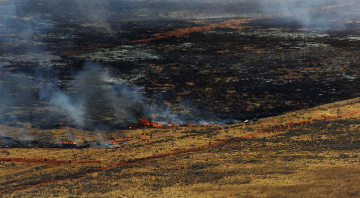 A wildfire burns in west Texas as fire fighting crews try to contain it, April 27. Airborne tankers lay lines of red fire retardant to help ground crews contain the fire.