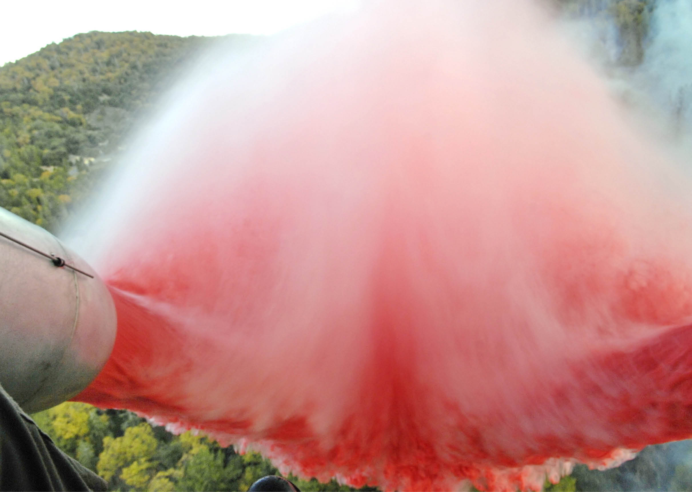Approximately 3,000 gallons of fire retardant is deployed Oct. 24 over the Poomacha Fire in North San Diego County, Calif. The C-130 Hercules and crew are assigned to the 302nd Airlift Wing from Peterson Air Force Base, Colo. The aircraft launched from Channel Islands Air National Guard Station, Calif. Air Force Reserve Command officials sent two of its designated firefighting C-130H3 aircraft to help battle the raging wildfires in Southern California. (U.S. Air Force photo/Tech. Sgt. Roy. A. Santana) 