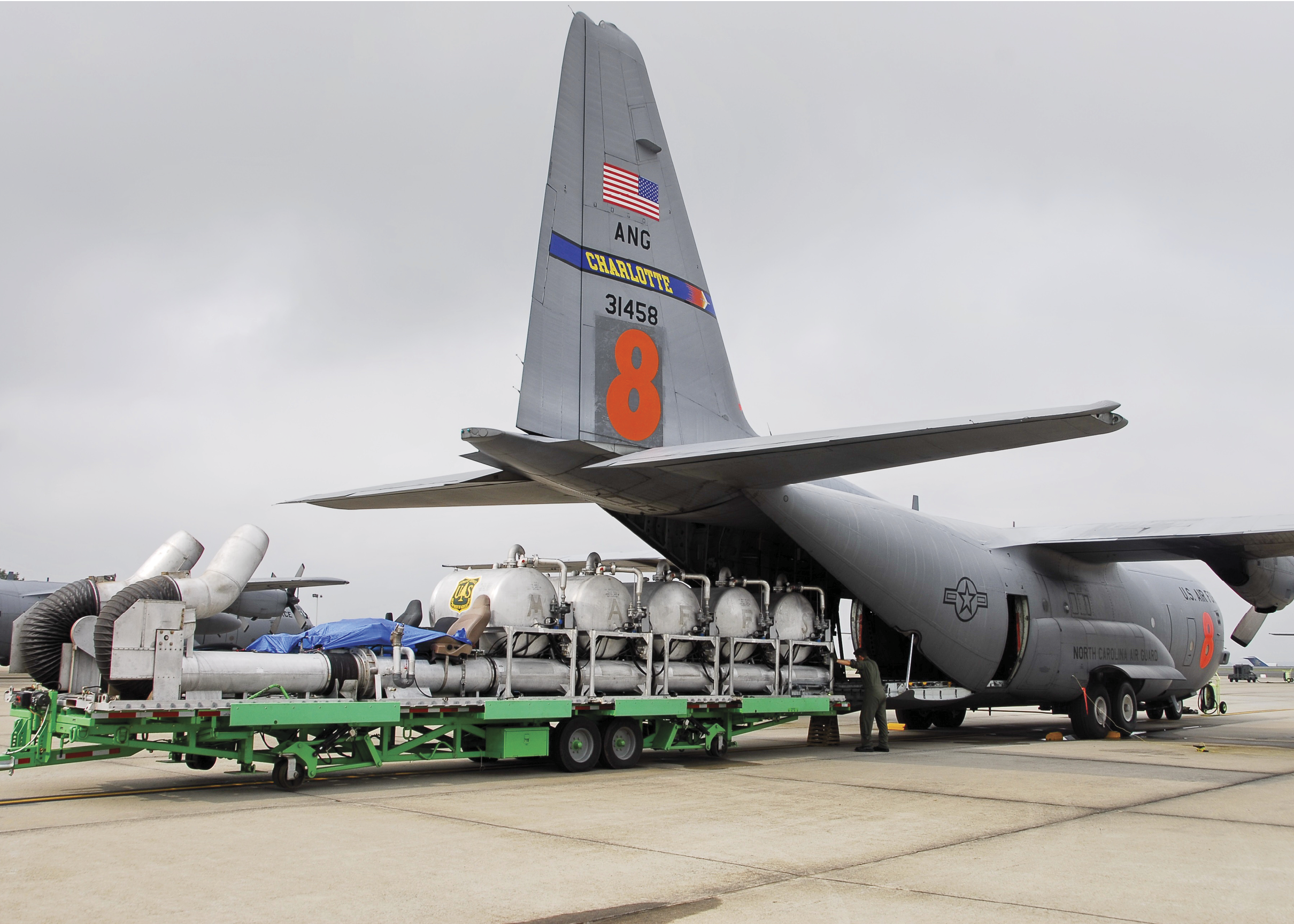 Flight line personnel prepare to insert a modular airborne fire fighting system unit into a C-130 Hercules aircraft assigned to the 145th Airlift Wing, North Carolina Air National Guard prior to its departure from Charlotte, N.C., June 23, 2008, for Northern California to combat wildfires. The pressurized tank system holds 3,000 gallons of flame-retardant liquid, which can be discharged in less than five seconds. The North Carolina Air National Guard has deployed four C-130 aircraft, their crews and various support personnel to Northern California to assist the U.S. Forest Service in containing wildfires in the area. (U.S. Air Force photo by Tech. Sgt. Brian E. Christiansen/Released)