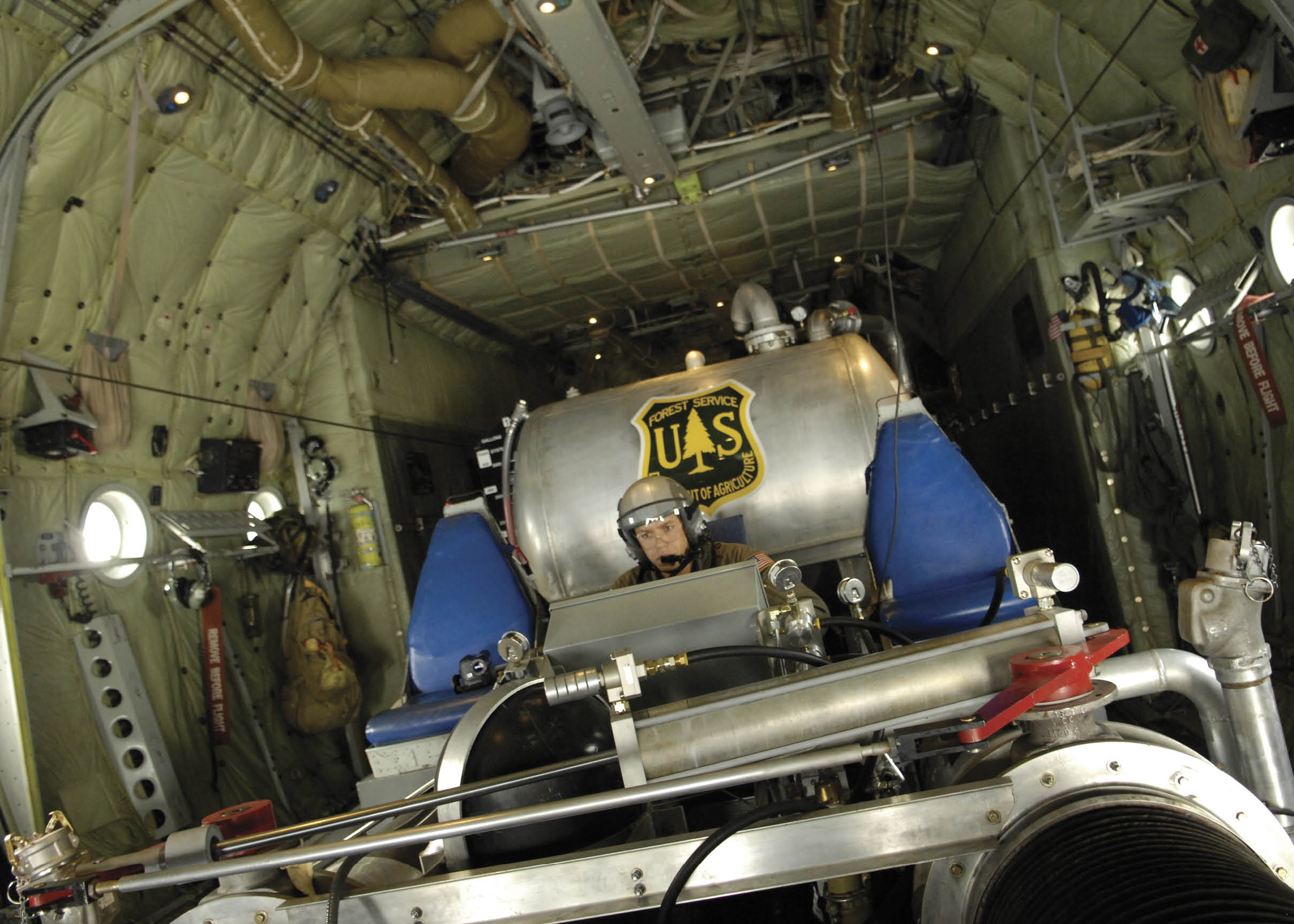 U.S. Air Force Tech. Sgt. Lamont Wood, from the 302nd Airlift Wing out of Peterson, Colo., prepares to deploy fire retardant in support of the California firefighting efforts. Oct. 25. The U.S. Air Force Reserve and Air National Guard are participating in the southern California firefighting effort. (U.S. Air Force Photo/Tech. Sgt. Roy A. Santana)