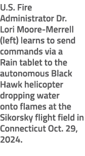 U.S. Fire Administrator Dr. Lori Moore Merrell (left) learns to send commands via a Rain tablet to the autonomous Bla...