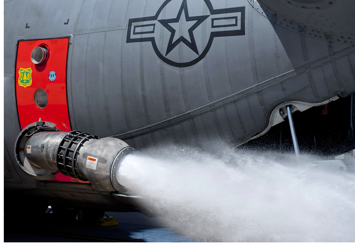 A U.S. Air Force C-130 Hercules aircraft from the 731st Airlift Squadron dispenses water from the Modular Airborne Fire Fighting System (MAFFS) during a certification and recurrent training exercise at Peterson Air Force Base, Colo., April 20, 2012. MAFFS is a portable fire retardant system that can be installed on C-130 Hercules aircraft to convert them into air tankers. MAFFS-certified military units partner with federal land management agencies to provide supplemental air tankers to assist in fire suppression efforts nationwide. (U.S. Air Force photo by Master Sgt. Adrian Cadiz/Released)