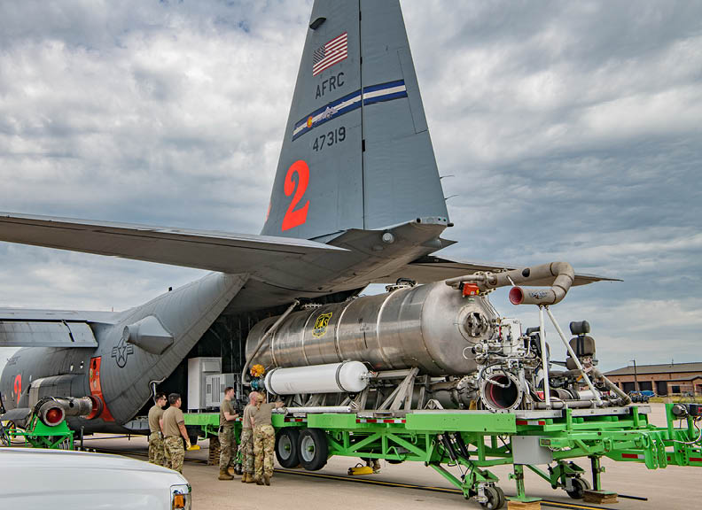 PETERSON SPACE FORCE BASE, Colo. -- A team of 302nd Airlift Wing Airmen load a U.S. Forest Service Modular Airborne Firefighting System unit into a C-130H aircraft at Peterson Space Force Base, Colorado, Aug. 1, 2023. The unit was installed in preparation to perform the 302 AW aerial firefighting special mission. The unit can be installed in approximately four hours with no structural modification to the air frame. (U.S. Air Force photo by Tech. Sgt. Justin Norton)