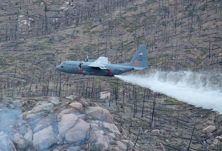 Reservist pilots and loadmasters assigned to the 302nd Airlift Wing drop potable water over Hayman Fire burn scar during their annual aerial wildland firefighting training and certification with the U.S. Department of Agriculture Forest Service, May 13, 2021, Pike-San Isabel National Forest, Colorado. The 302 AW and 153rd Airlift Wing C-130 Hercules aircraft, equipped with the U.S. Forest Service €™s Modular Airborne Fire System, began their weeklong training and certification out of Jeffco Airtanker Base, Colorado, where they conducted training drops with potable water at nearby Arapaho/Roosevelt and Pike-San Isabel National Forests and Bureau of Land Management lands. (U.S. Air Force photo by Tech. Sgt. Justin Norton)