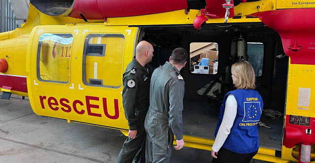 Three people are standing in front of a yellow and red helicopter. AI generated content