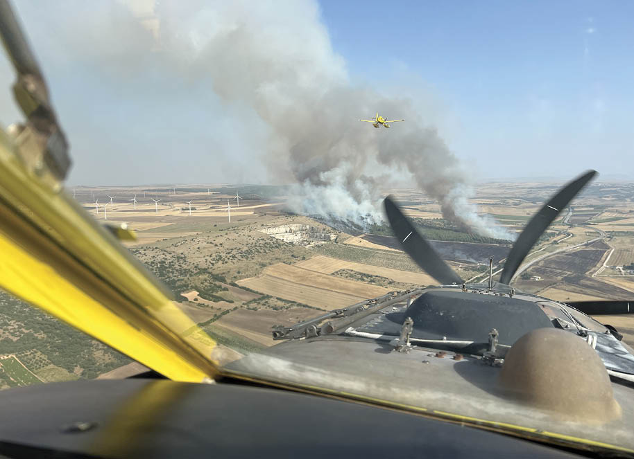 A plane flying in the sky with smoke coming out of it. AI generated content