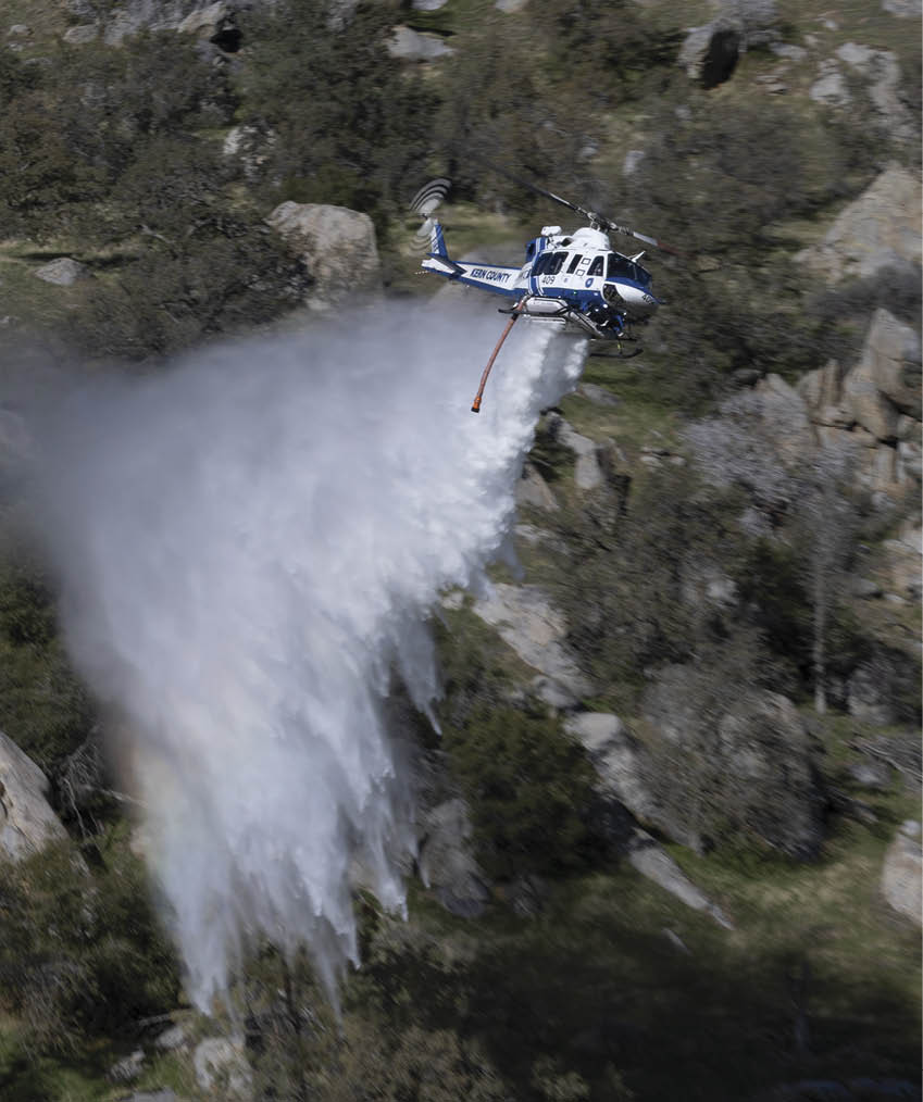 A helicopter is spraying water on a hillside. AI generated content