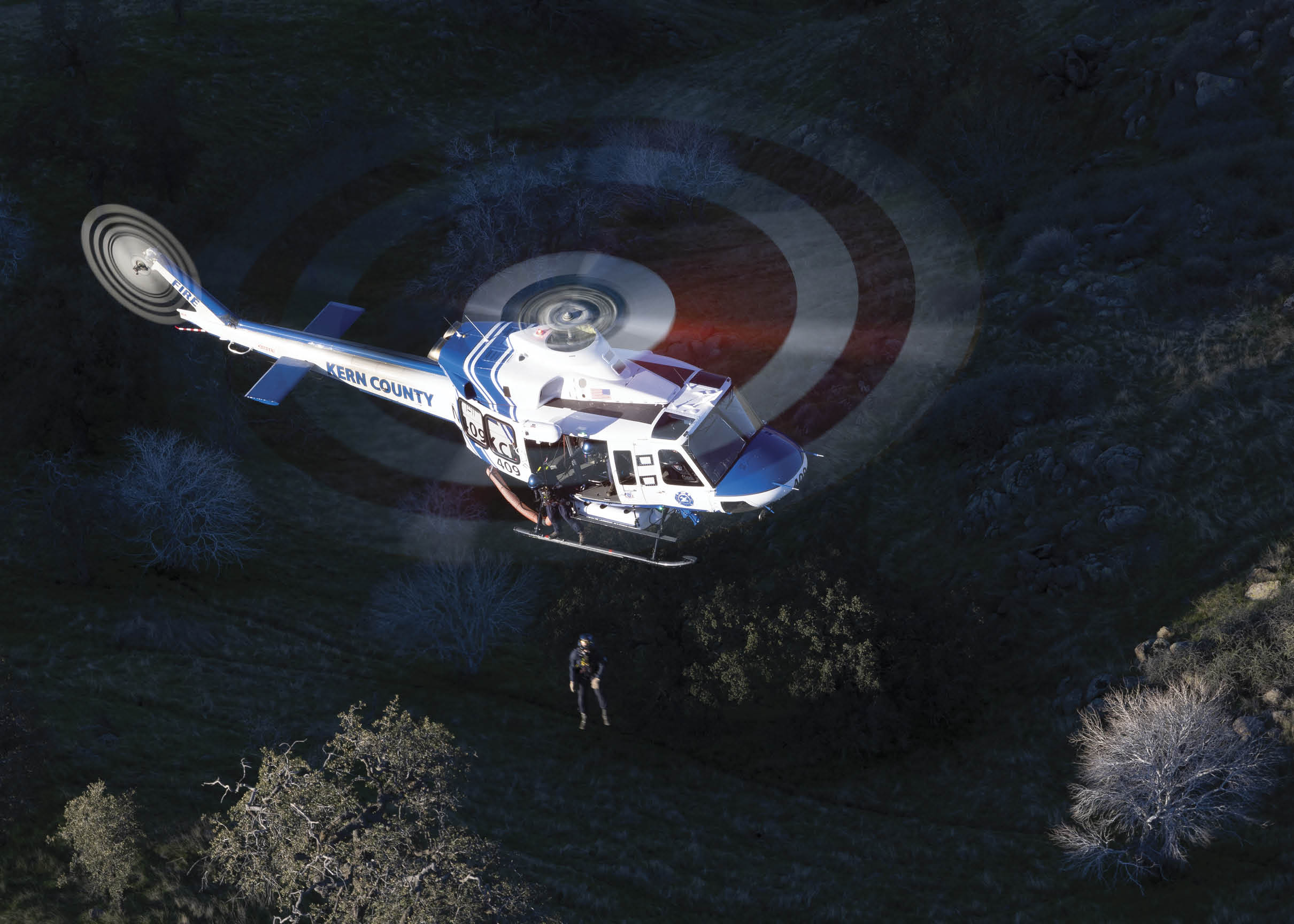 A helicopter is flying in the air with a red bullseye on the ground. AI generated content