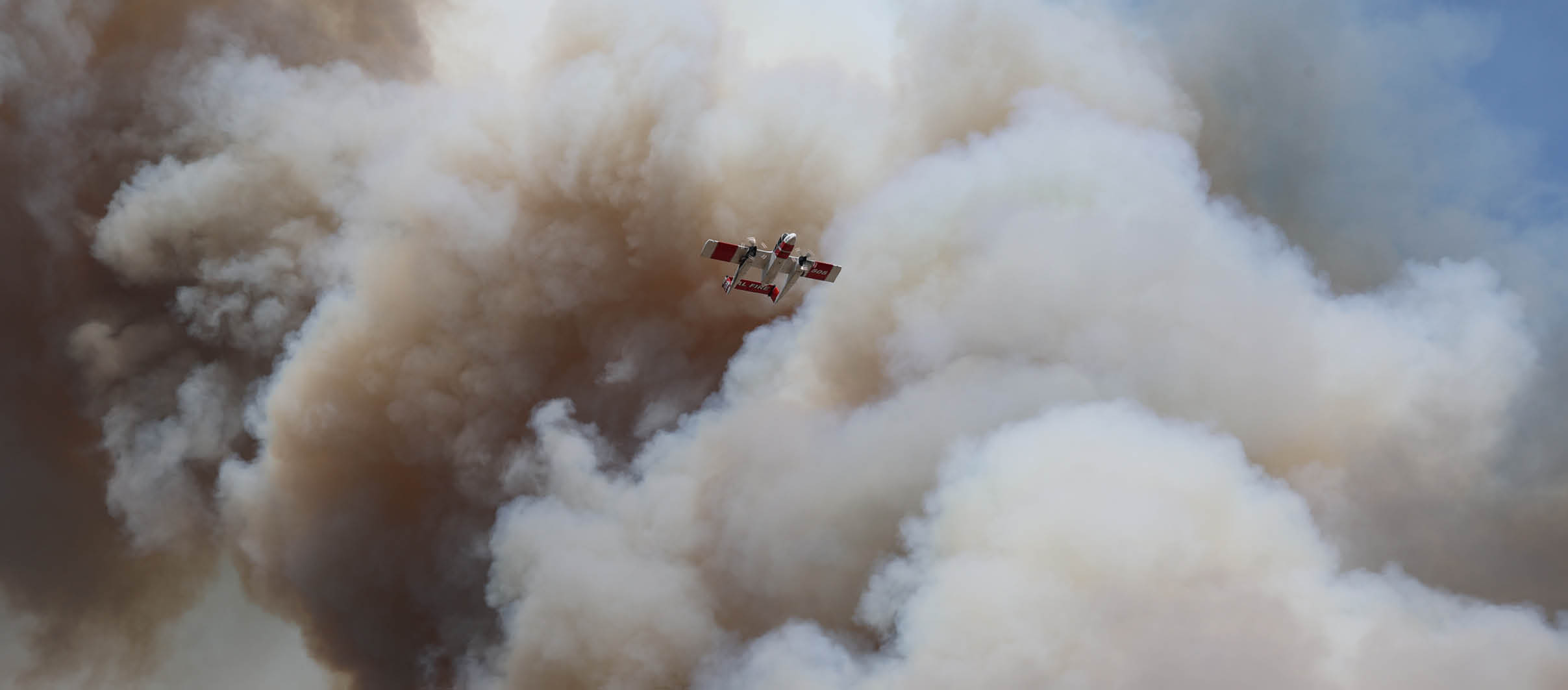 A plane is flying through a cloud of smoke, with the smoke appearing to be a mix of orange and white. AI generated content
