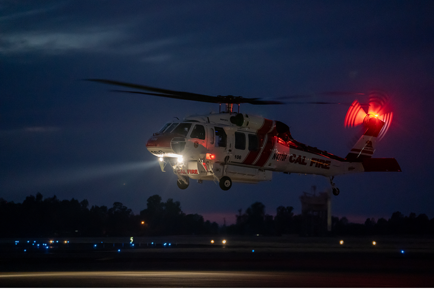 A helicopter with a red light on its tail is flying in the air. AI generated content