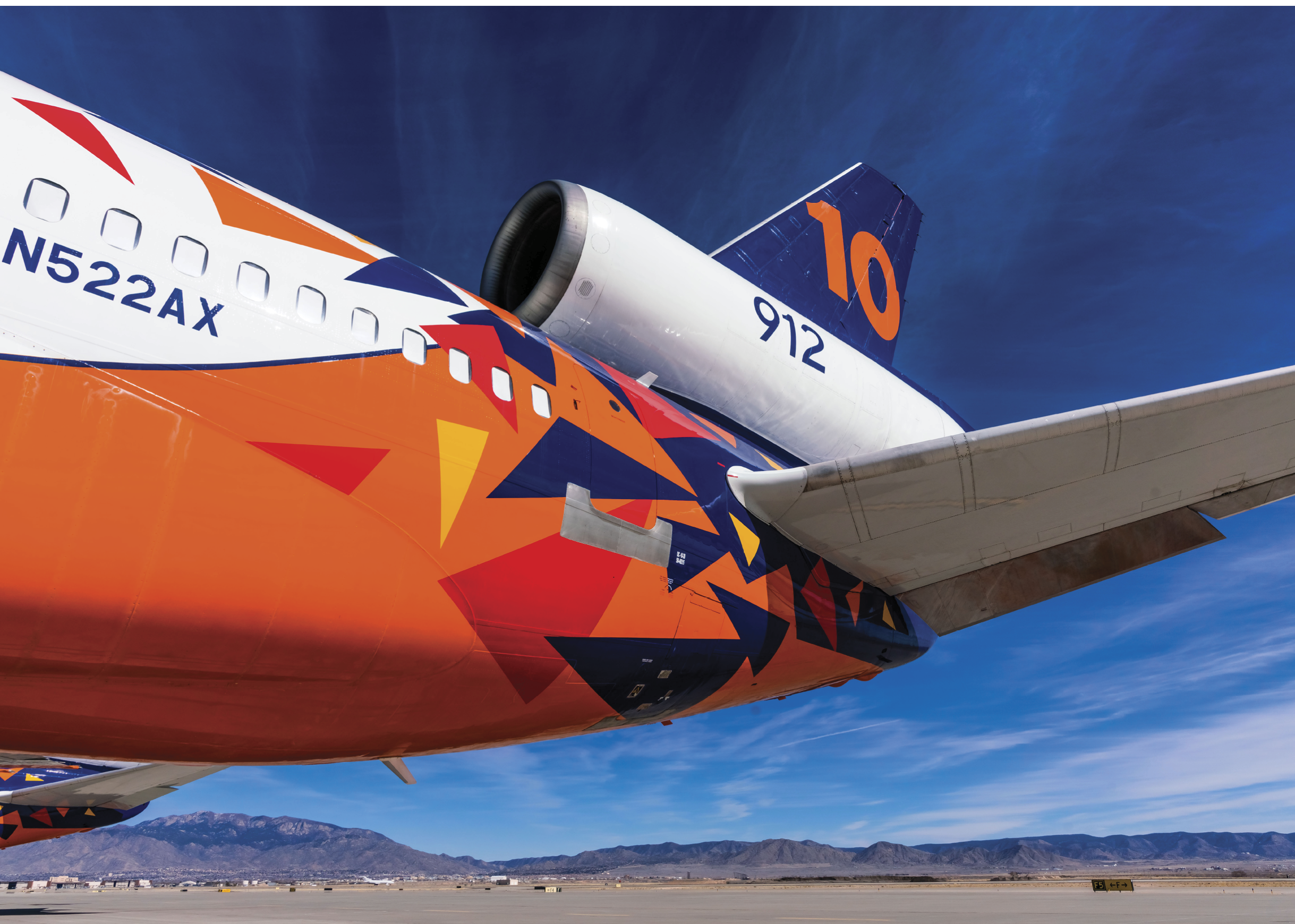 A large airplane with a colorful tail and the number 10 on the tail. AI generated content