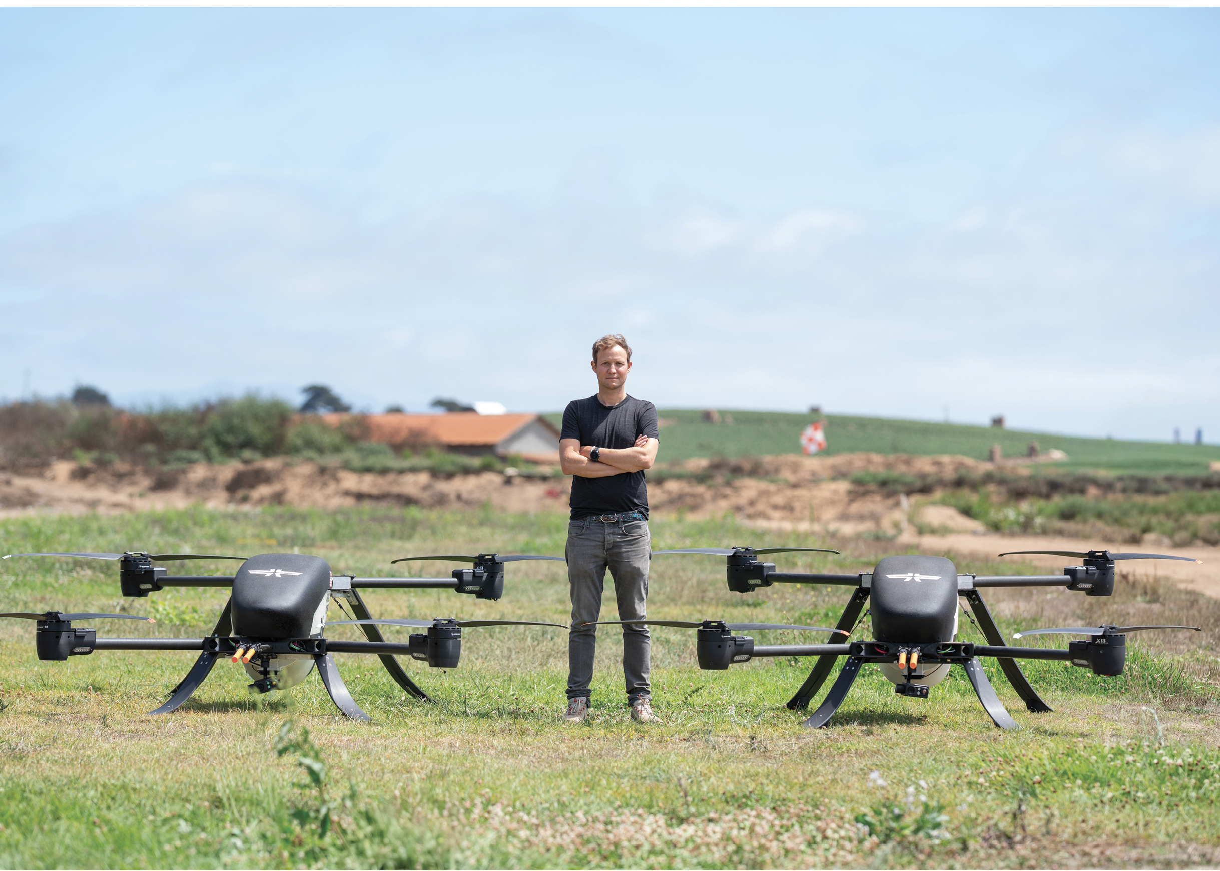 Two black drones are sitting on the grass. AI generated content
