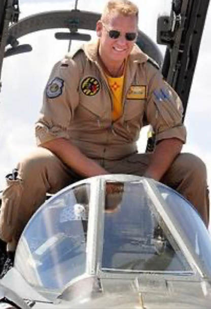 A man wearing a military uniform is sitting in the cockpit of a fighter jet. AI generated content