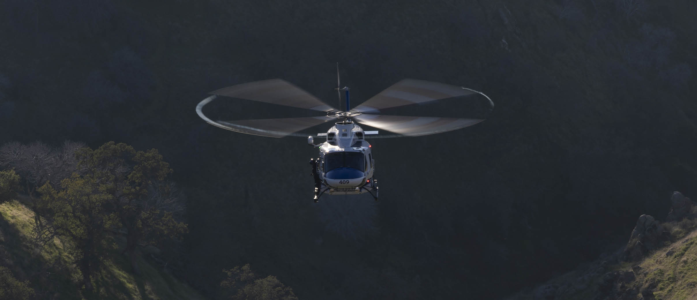 A helicopter is flying in the air with its blades spinning. AI generated content