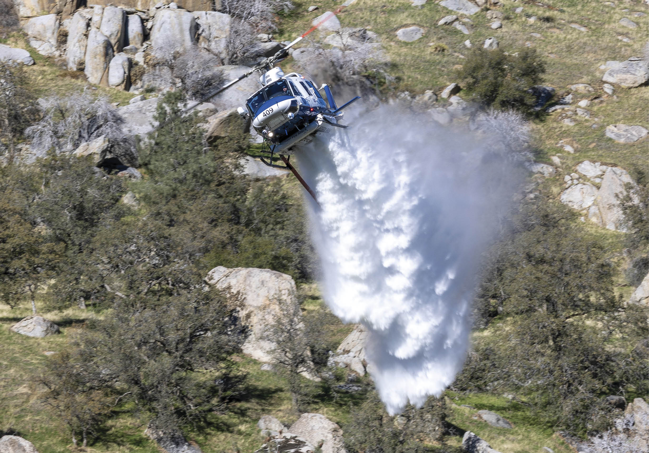 A helicopter is flying through the air, spraying water. AI generated content