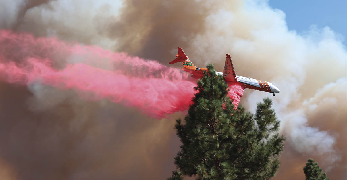 A red and orange fire hose is shooting water into the air. AI generated content