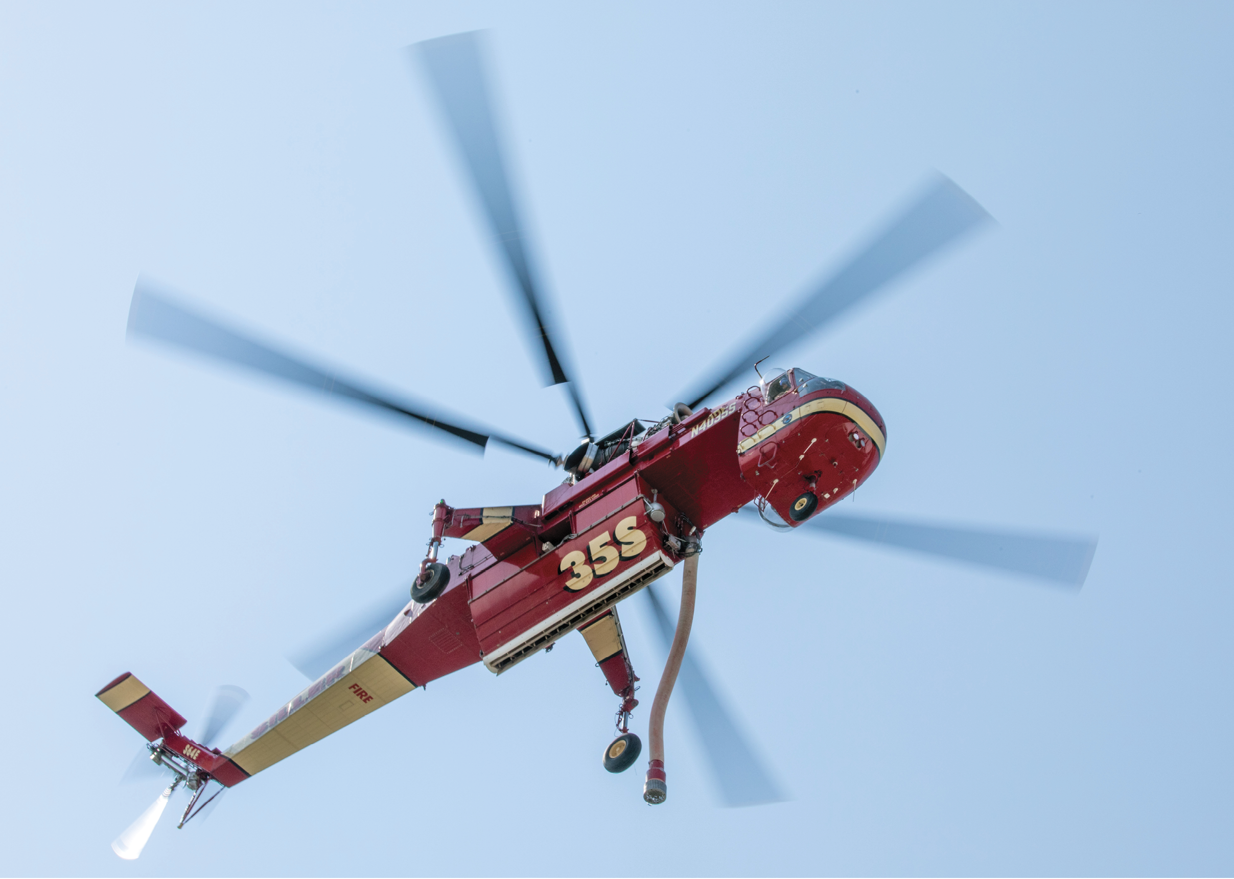 A red helicopter with a number 32 on it is flying in the air. AI generated content