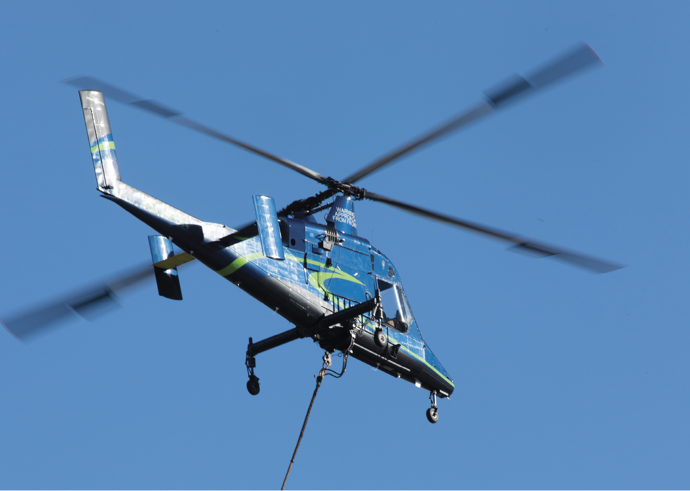 A helicopter is flying in the air with a rope attached to it. AI generated content