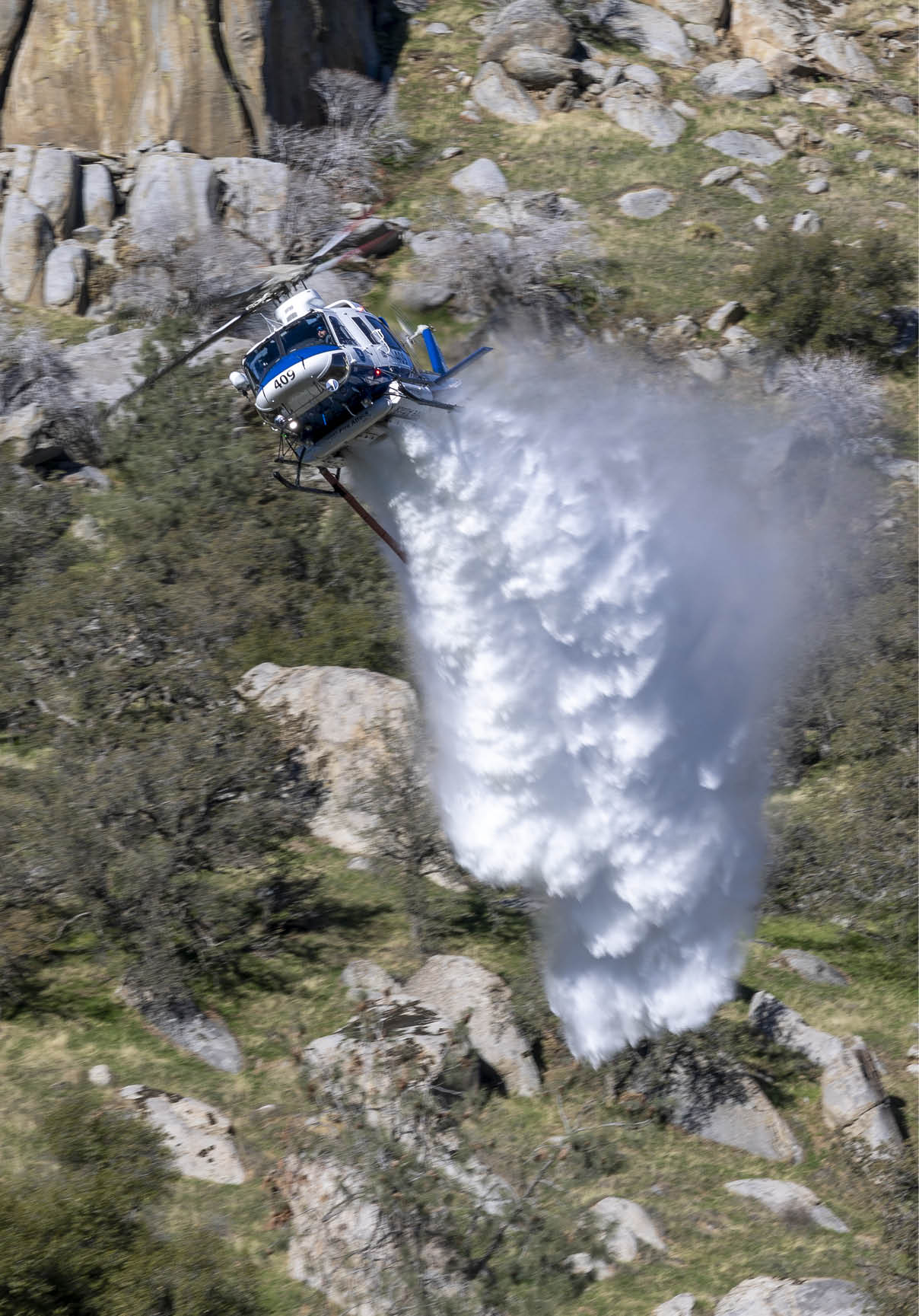 A helicopter is flying over a waterfall, spraying water into the air. AI generated content