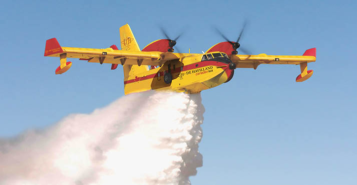 A yellow and red airplane is flying through the sky, leaving a trail of smoke behind it. AI generated content