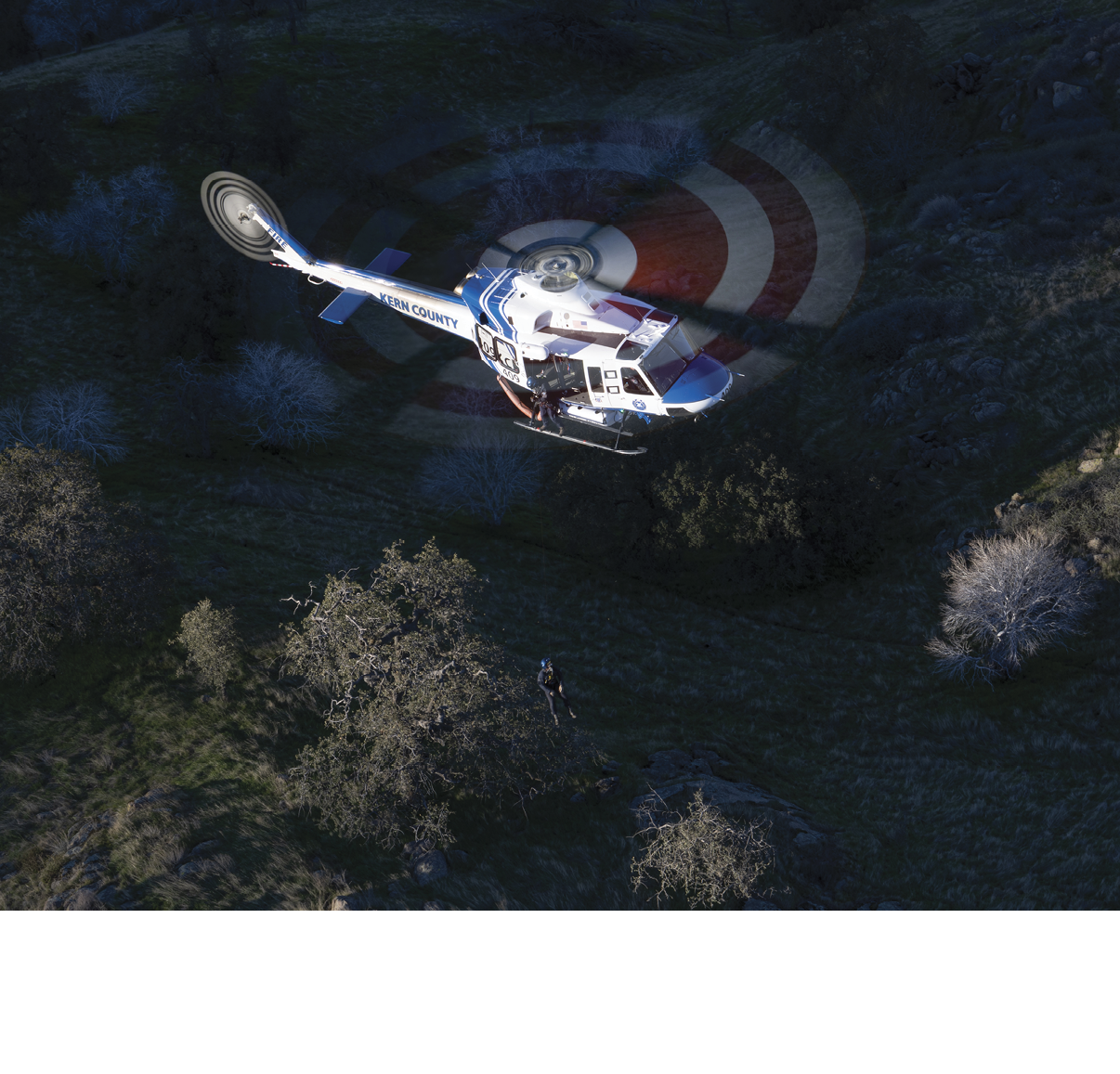 A helicopter is flying over a field with a red bullseye on the ground. AI generated content