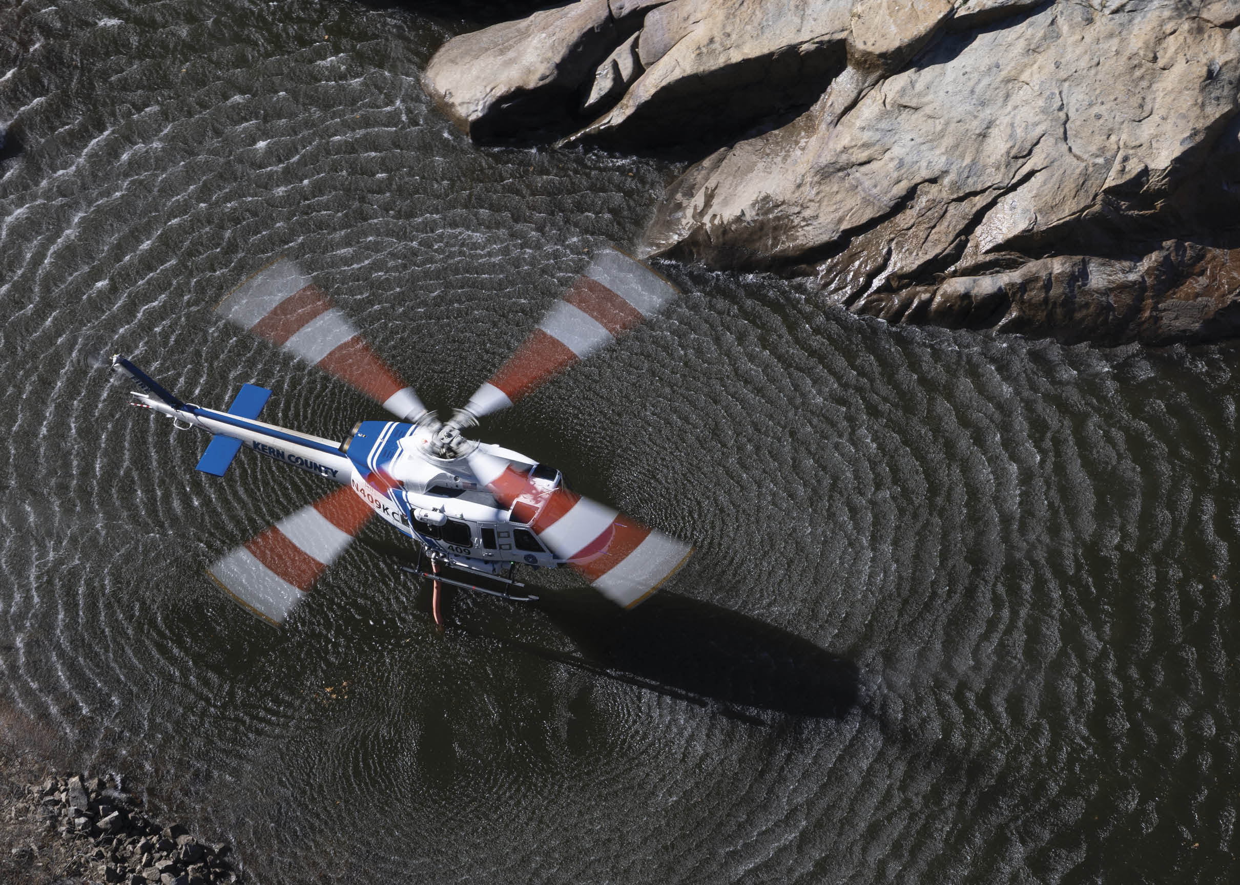 A helicopter is floating on the water, with its propeller spinning. AI generated content