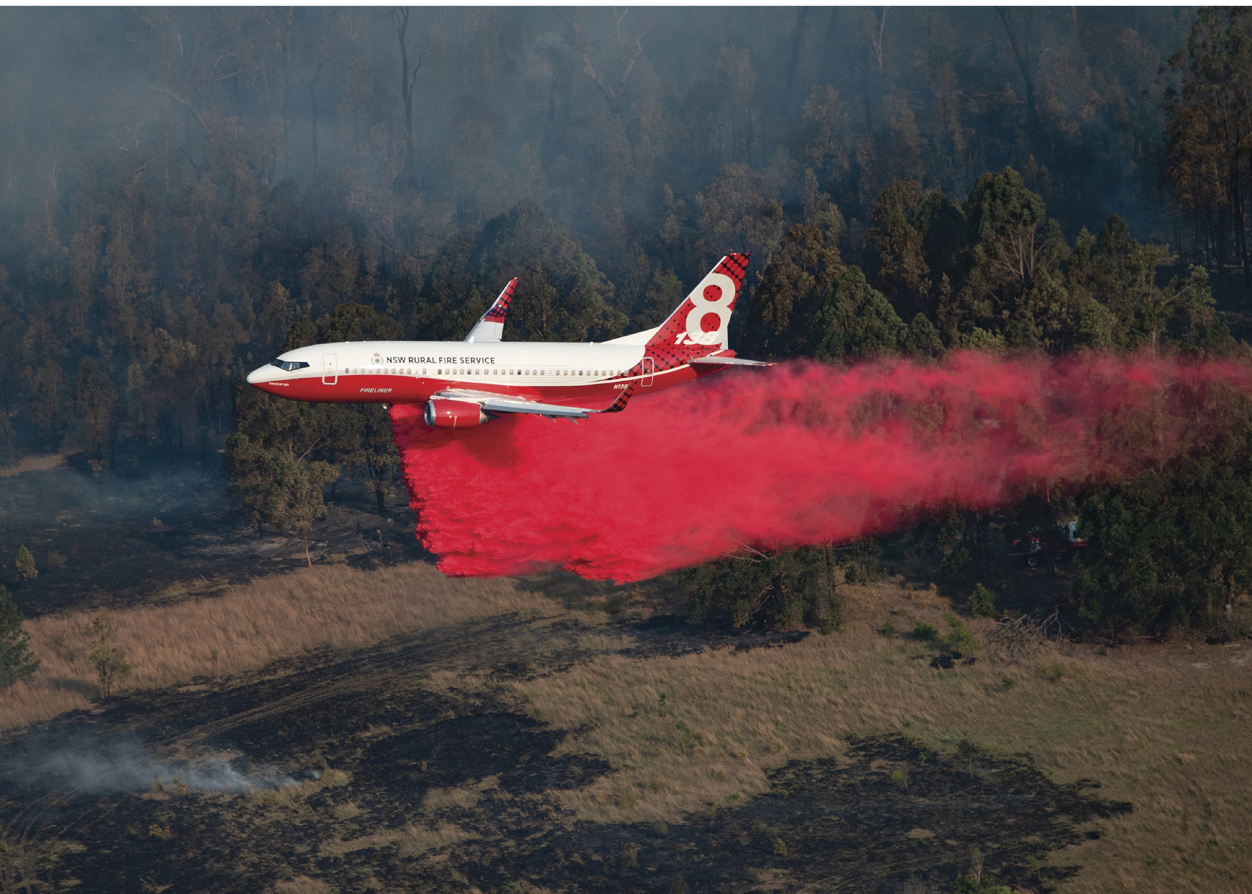 A red and white airplane is flying through a field with smoke trailing behind it. AI generated content