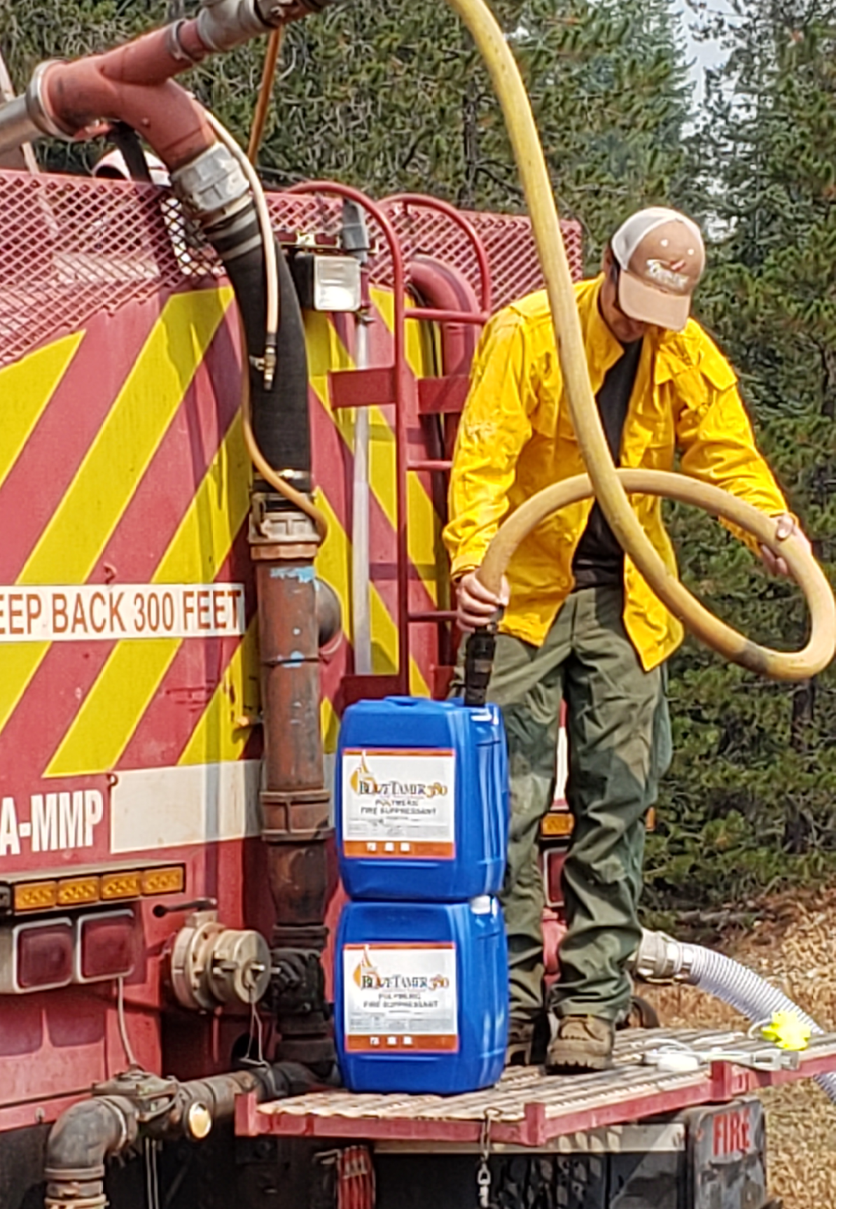 A man is standing on a red truck, holding a hose. AI generated content