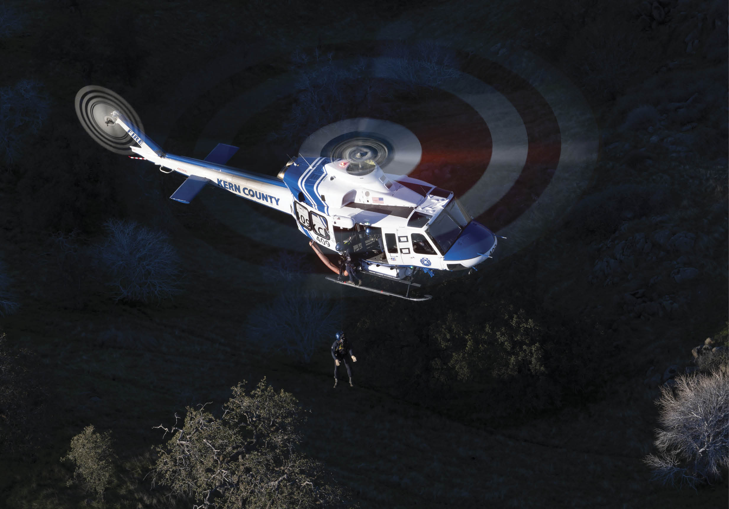 A helicopter is flying over a field with a person standing in it. AI generated content