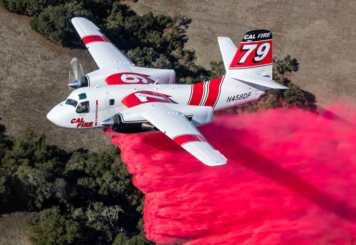 A yellow and red airplane is flying through the sky, leaving a trail of smoke behind it. AI generated content