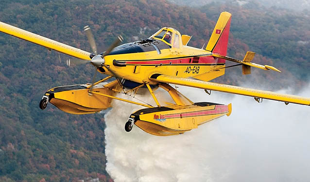 Three airplanes are parked on the tarmac, with one being yellow and red. AI generated content