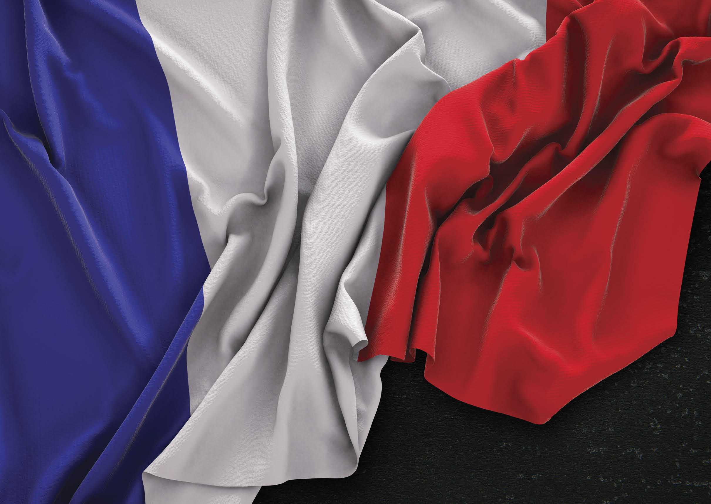 A wrinkled fabric flag with vertical stripes of blue, white, and red lying on a dark textured surface. Description generated by AI