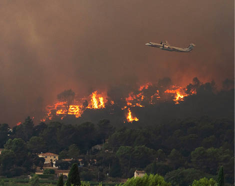 A helicopter is flying over a city at night, with a fire visible in the distance. AI generated content