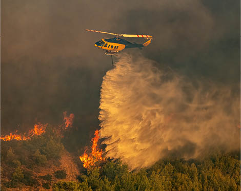 A helicopter is flying over a city at night, with a fire visible in the distance. AI generated content