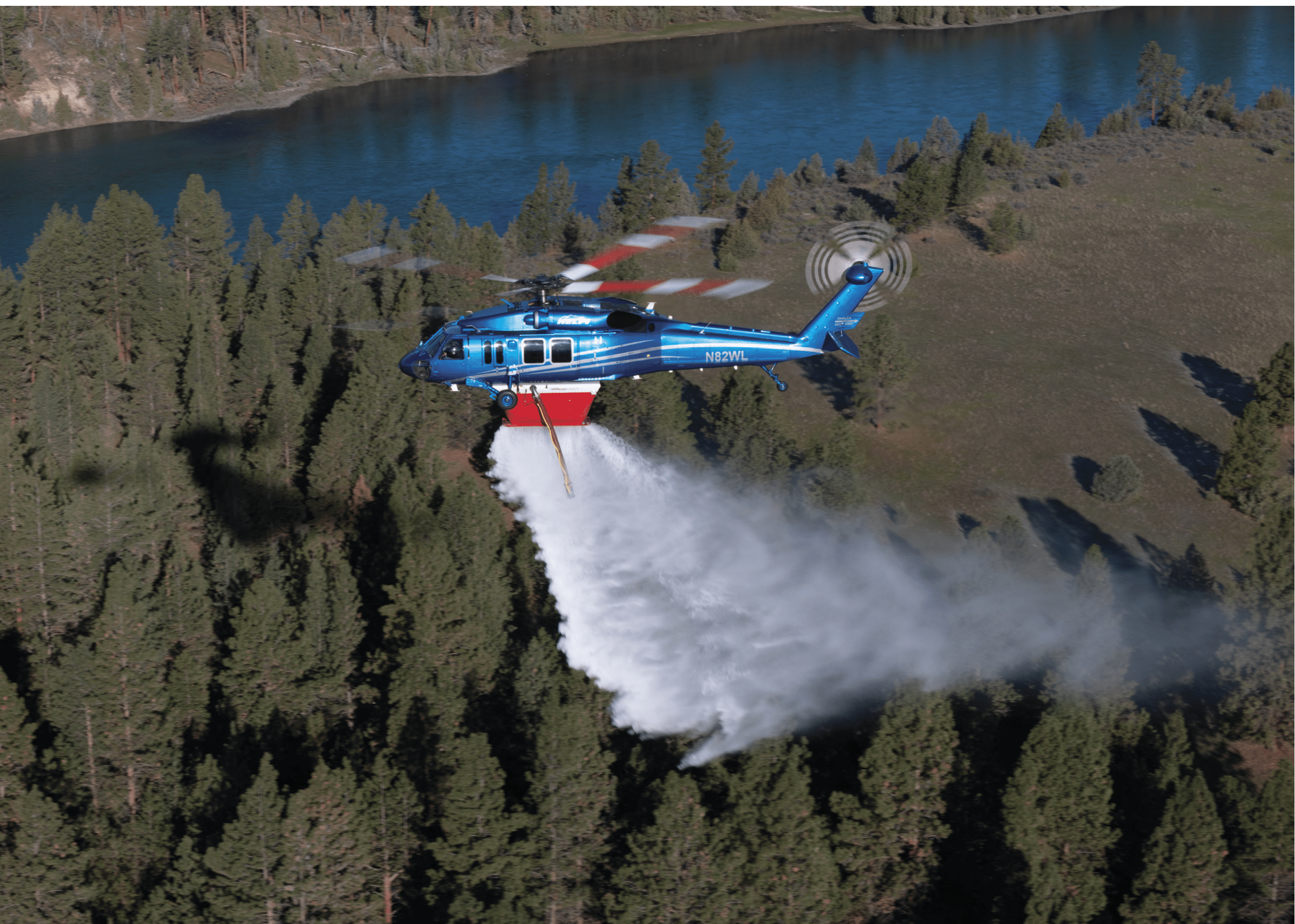 A yellow and blue helicopter is flying through the sky, leaving a trail of smoke behind it. AI generated content