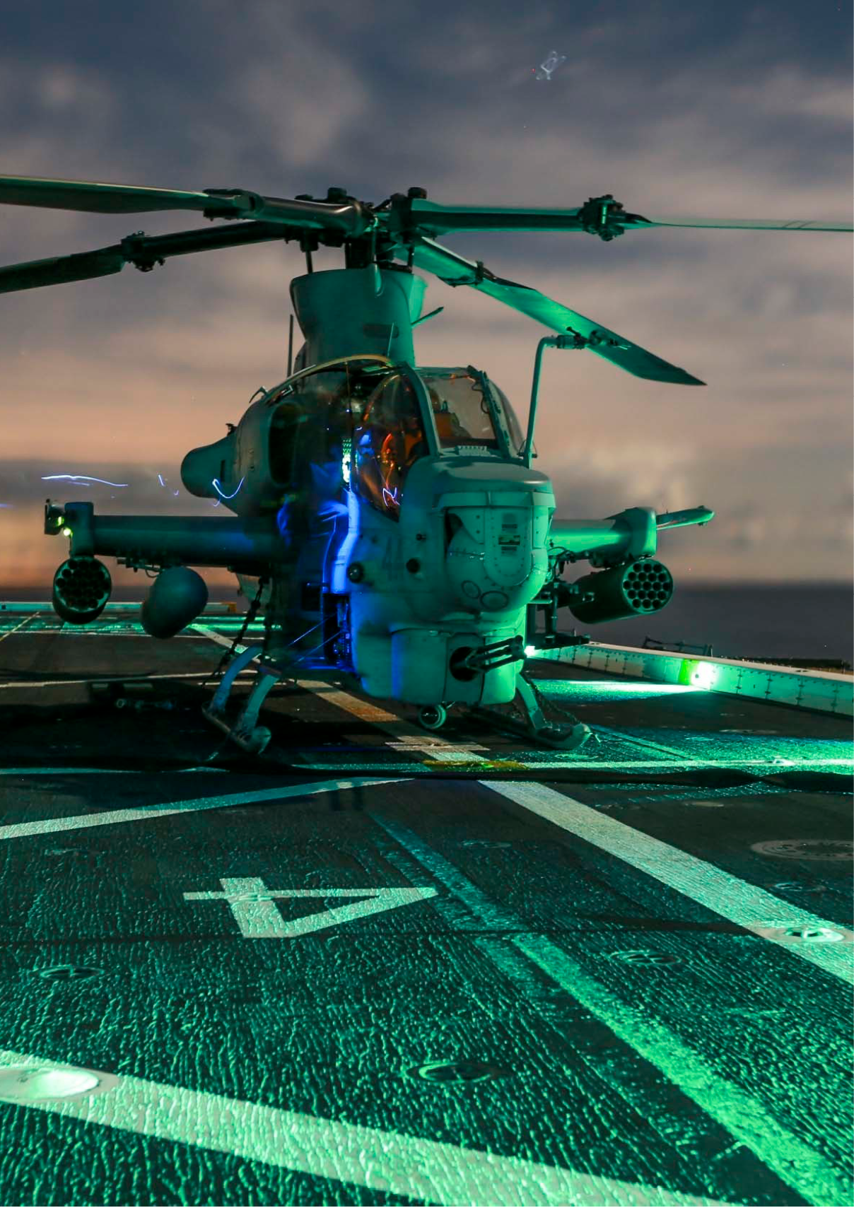 U.S. Marines perform maintenance checks on an AH-1Z Viper with Marine Medium Tiltrotor Squadron 161 (Reinforced), 15th Marine Expeditionary Unit, aboard the USS Anchorage (LPD 23) during Amphibious Squadron/Marine Expeditionary Unit Integration Training (PMINT) off the coast of San Diego March 2, 2015. The pilots of VMM-161 (Rein) were practicing take-offs and landings at night to maintain proficiency aboard ship.  (U.S. Marine Corps photo by Sgt. Jamean Berry/Released)