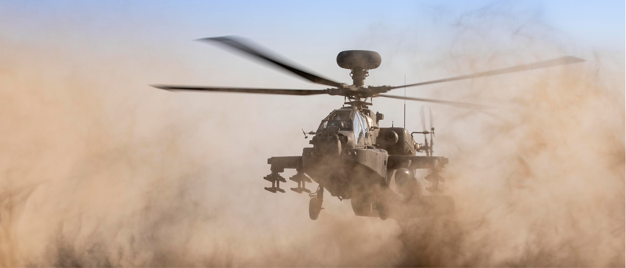 The AH64 Apache conducts dust landings while deployed to RAFO Musannah as part of Ex PINION OMAN 21. Force elements from across the 1st Aviation Brigade Combat Team (1AvnBCT) recently deployed on Exercise PINION OMAN 21 (ExPO21) to conduct essential desert environmental training and live firing prior to supporting 1 (UK) Division on Exercise KHANJAR OMAN 21. The training and qualifications also ensure lead elements of 1AvnBCT who are held are Extremely High Readiness are equipped to react to a multitude of potential threats, able to deploy globally as well as support standing operational commitments in the homeland.  In order to support the deployment, maintain serviceability and readiness of the aircraft, personnel from the Army Air Corps, Royal Electrical and Mechanical Engineers, Royal Logistics Corps, Royal Air Force and Royal Navy work day and night in challenging conditions to conduct vital maintenance, repair, refuel and support. These personnel are the vital enablers which assure that each aircraft is maintained to the highest standard and set the conditions for the aircrew to continuingly fly in some of the harshest conditions in the world.