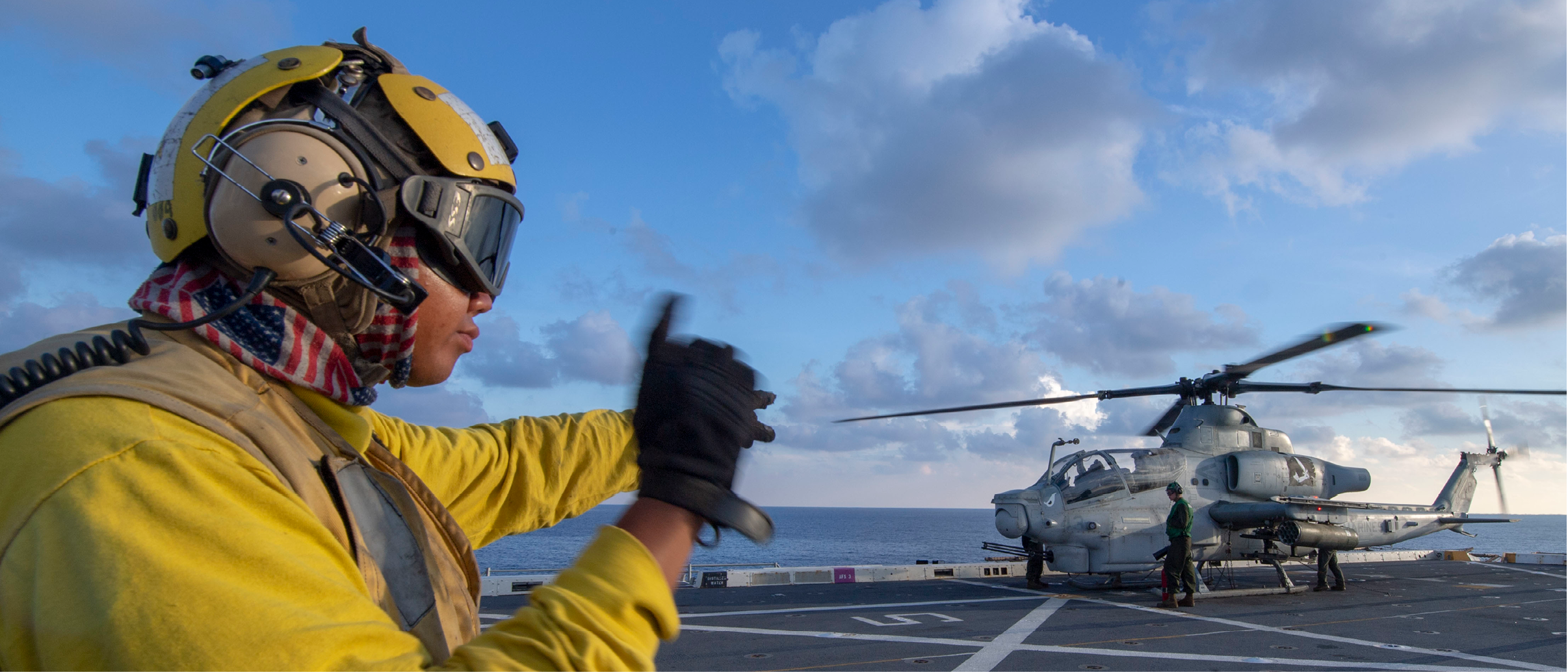 191003-N-NB544-1265 SOUTH CHINA SEA (Oct. 3, 2019) Aviation Boatswain's Mate (Handling) 2nd Class Joseph Onadia, from Detroit, signals to AH-1Z Viper pilots, assigned to Marine Medium Tiltrotor Squadron (VMM) 163 (Reinforced), aboard the amphibious transport dock ship USS John P. Murtha (LPD 26). John P. Murtha is currently on its first deployment and part of the Boxer Amphibious Ready Group (ARG) and 11th Marine Expeditionary Unit (MEU) team and is deployed to the U.S. 7th Fleet area of operations to support regional stability, reassure partners and allies, and maintain a presence postured to respond to any crisis ranging from humanitarian assistance to contingency operations. (U.S. Navy photo by Mass Communication Specialist 2nd Class Kyle Carlstrom)