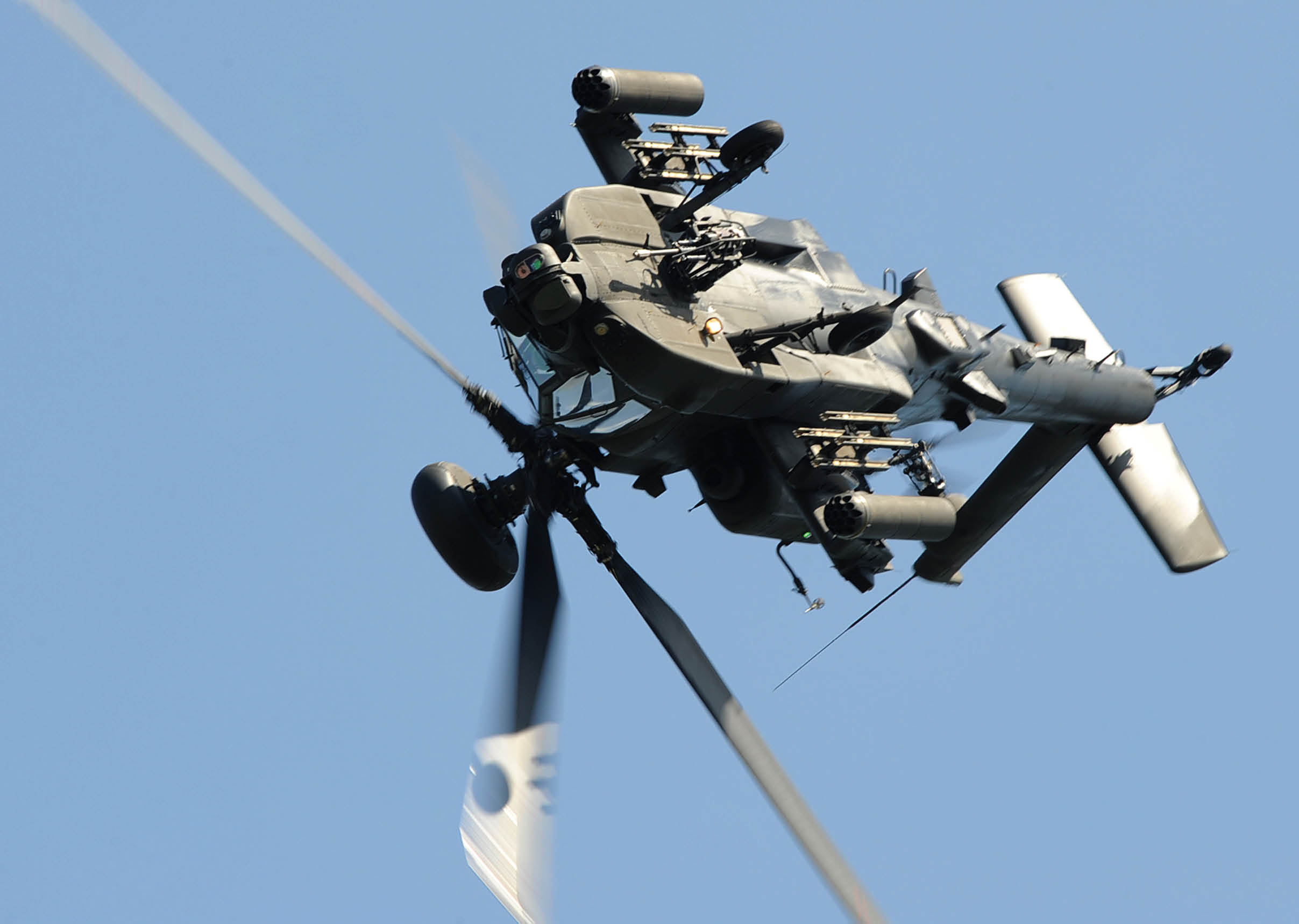 An Army Air Corps Apache of the Apache Attack Helicopter Display Team thrills the crowds at the RAF Cosford airshow. On the 9th June 2013 Royal Air Force Cosford hosted their annual Airshow, attended by thousands of people from across the country.   Captain Wales flew as part of the Army Air Corps Apache Attack Helicopter Display Team (AHDT) at the RAF Cosford Air Show.  The AHDT comes from 3 Regiment AAC, which is part of the Attack Helicopter Force within 16 Air Assault Brigade.  Each year, crews are selected for their expertise and skills in flying and operating the Apache, and have a considerable amount of operational experience, mainly from Afghanistan, and also Libya.   The AHDT is not an aerobatic team and therefore does not require enhanced flight authorisations; instead, the operational aircrew have been thoroughly trained to perform manoeuvres within the Release to Services of the Apache helicopter at annual Air Shows.   The Apache Force provides near all weather Surveillance, Presence, Deterrence and when needed Close Combat Attack capabilities on operations, as well as an escort role to other aircraft. The aircraft is a versatile, multi-role attack platform capable of delivering effect across the full spectrum of operations from both land and sea.        