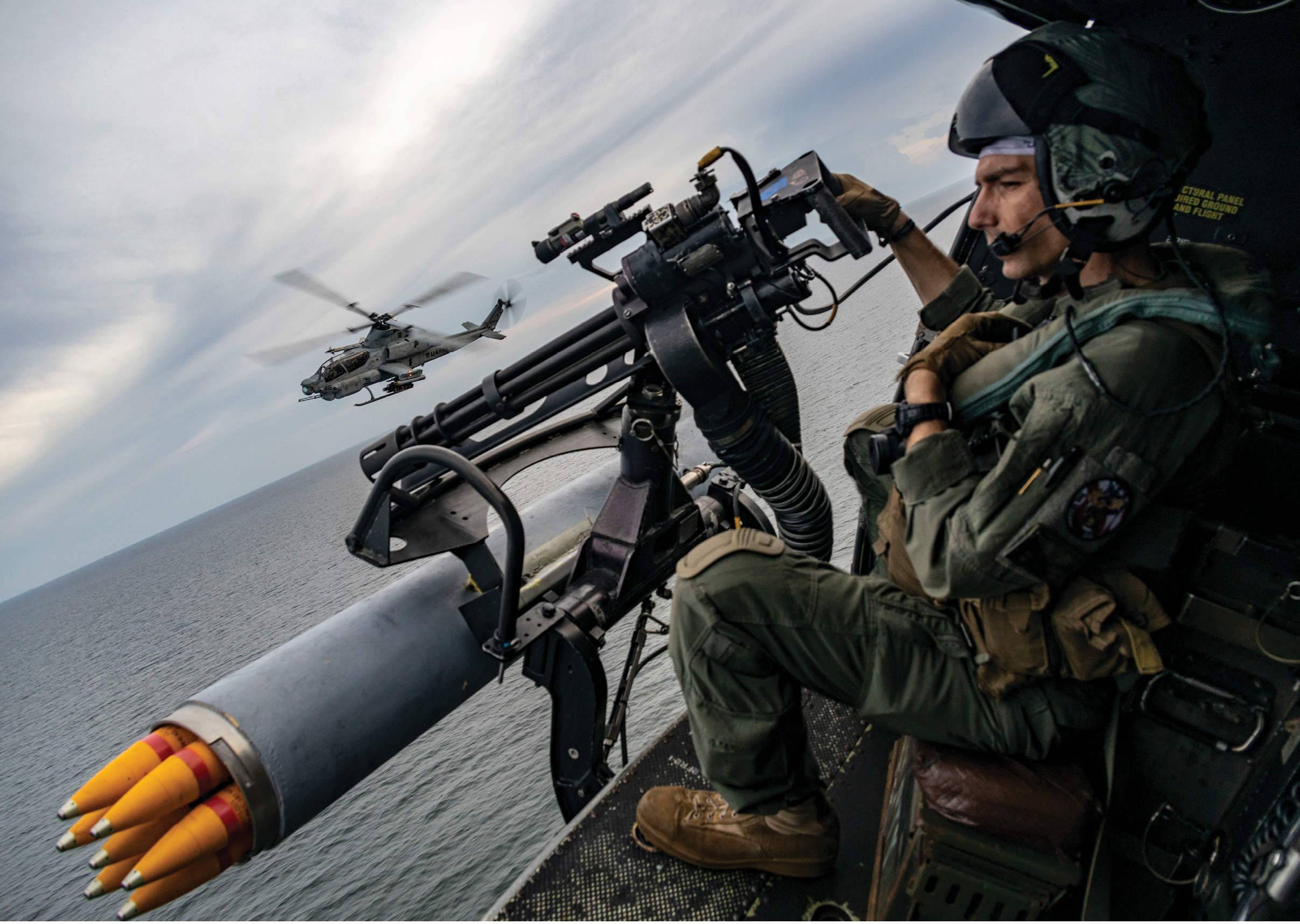 U.S. Marine Corps Sgt. Raylin Carter, an aerial observer from Oklahoma with Marine Medium Tiltrotor Squadron (VMM) 362 (Reinforced), 13th Marine Expeditionary Unit, participates in flight operations with AH-1Z Viper pilots during a strait transit, Jan. 9, 2023, The 13th MEU is embarked on the Makin Island Amphibious Ready Group, comprised of amphibious assault ship USS Makin Island (LHD 8) and amphibious transport dock ships USS John P. Murtha (LPD 26) and USS Anchorage (LPD 23), and operating in the U.S. 7th Fleet area of operations. 7th Fleet is the U.S. Navy's largest forward-deployed numbered fleet, and routinely interacts and operates with Allies and partners in preserving a free and open Indo-Pacific region. (U.S. Marine Corps photo by Cpl. Austin Gillam)