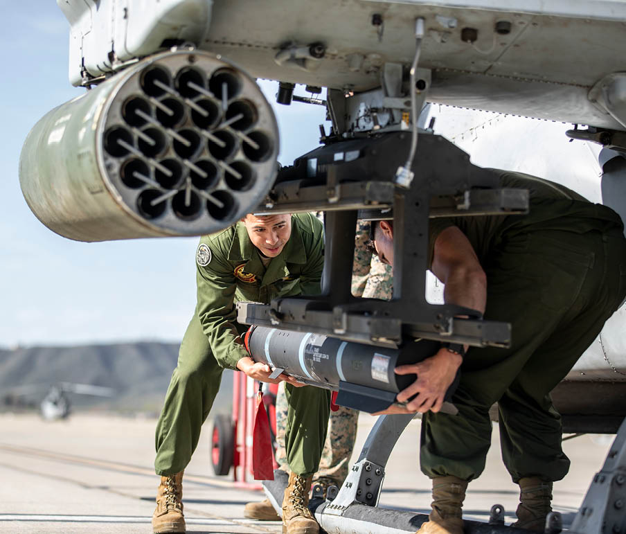 U.S. Marines with Marine Light Attack Helicopter Squadron 267, Marine Aircraft Group 39, 3rd Marine Aircraft Wing, load a joint air-to-ground missile (JAGM) onto an AH-1Z Viper at Marine Corps Air Station Camp Pendleton, California, March 2, 2022. The purpose of the JAGM is to support expeditionary advanced base operations, such as conducting strikes and close air support missions. (U.S. Marine Corps photo by Sgt. Samuel Ruiz)